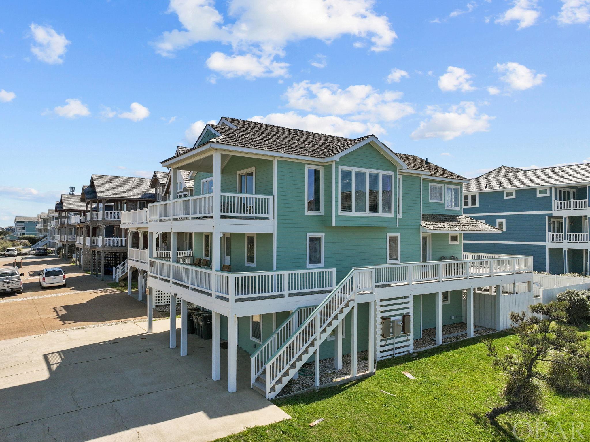 Welcome to your coastal paradise! Nestled on a corner lot where E. Mall Dr. meets the Beach Road in the charming Village of Nags Head, this semi-oceanfront gem boasts everything you desire in beachfront living.  Step inside this magnificent 7-bedroom, five and 1/2-bath retreat, where luxury meets comfort at every turn. With an elevator providing convenient access to all levels, indulgence is effortless.  Relax and unwind in style with your own private pool and rejuvenating hot tub, perfect for soaking in the salty sea breeze. The expansive decking offers breathtaking ocean views, setting the scene for unforgettable sunsets and lazy afternoons.  Entertainment knows no bounds in the spacious game room and kitchenette providing endless fun for family and friends.  This home is a testament to luxury living, with recent upgrades in 2023 including a fresh coat of paint, new furniture, bedspreads, lamps, and refinished hardwood floors and steps. Embrace culinary excellence in the fully-equipped kitchen featuring all-new appliances.  The top-level primary suite offers a serene sanctuary, while four additional bedrooms on the mid-level and two on the ground level ensure ample space for everyone to rest and recharge.  Indulge in the ultimate coastal lifestyle with the added convenience of The Village of Nags Head amenities, including a shuttle bus, 2 Sound accesses, ocean access with parking, and a bathhouse just a stone's throw away.  Whether you're seeking a lucrative rental investment or envisioning your dream home by the sea, this remarkable property offers it all. Don't miss the opportunity to make coastal living your reality – schedule your showing today!