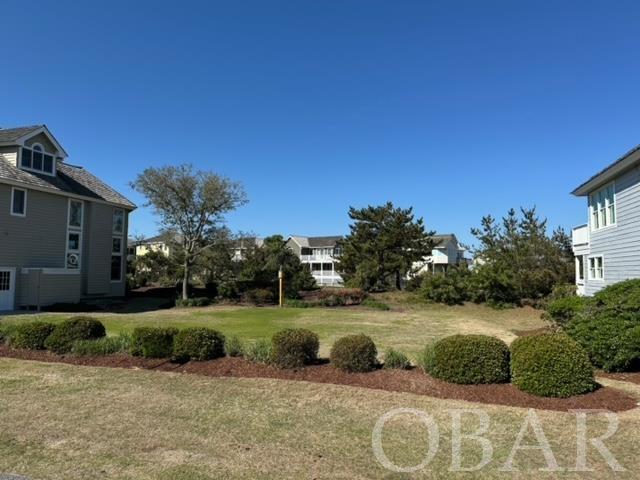 One of the few remaining buildable lots in one of the premiere communities on the Outer Banks- the Village at Nags Head. This lot is 33% larger than the average Captain's Watch lot and will offer some golf course and sound views, as well as stunning sunset views. Build your dream home and enjoy all that the Village at Nags Head has to offer: 2 soundside piers and oceanfront bathhouse with private parking. It also offers has a community septic system (no private septic) and separate memberships for the Village Beach Club and award-winning Nags Head Golf Links. This lot is cleared and ready for a home. Don't miss this rare opportunity to build your dream home in the Village at Nags Head.
