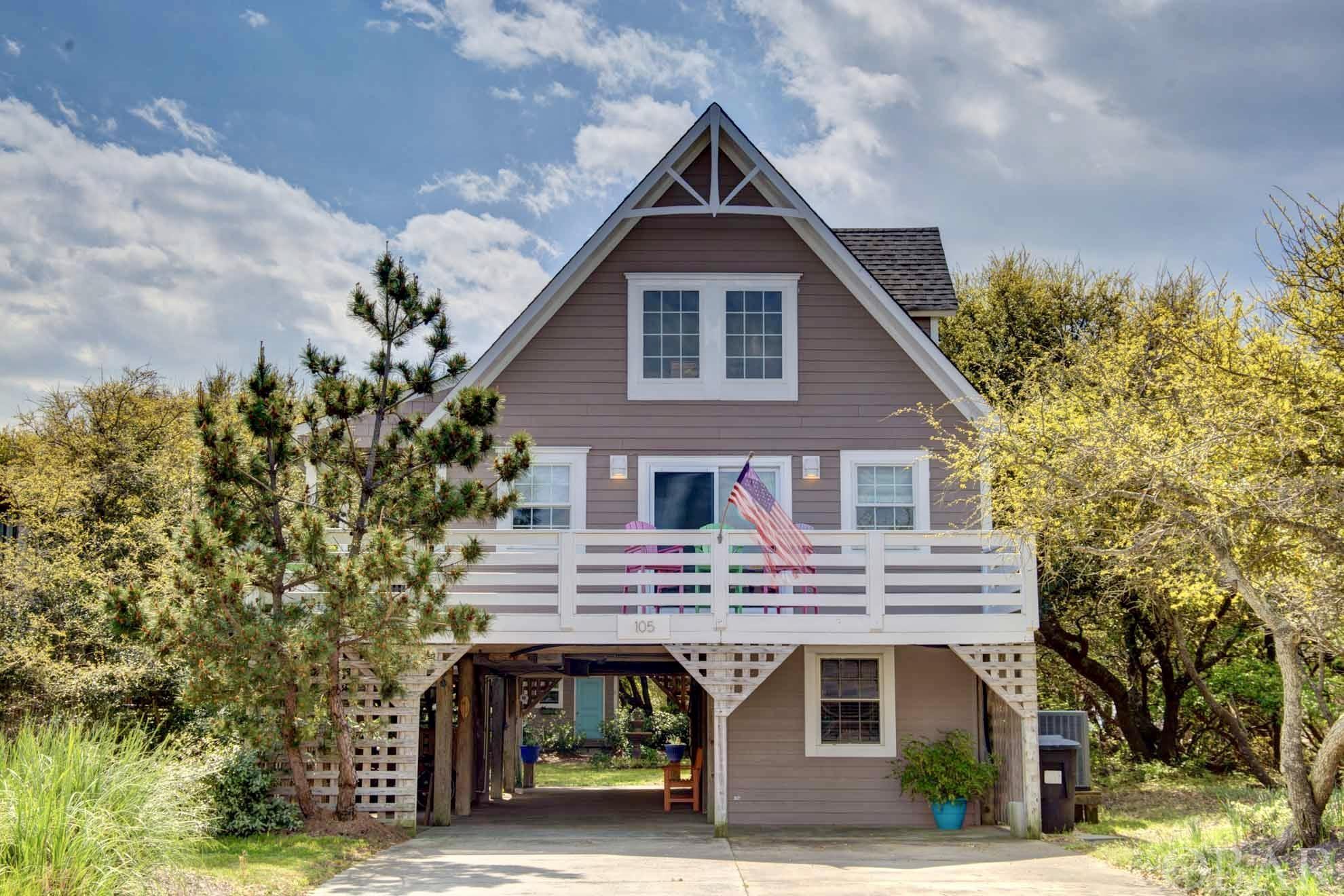 This charming renovated cottage is centrally located in the heart of Kill Devil Hills, just a short distance to the public beach access. Enjoy 3 bedrooms and 2 full baths upstairs, and a separate ground-level unit with 1 Bed, a full bathroom, and kitchenette. The private yard shaded by gorgeous live oak trees is perfect for relaxing and playing yard games. Outdoor boasts pea stone patio, private outdoor shower, main deck with dining table for 8, an extremely private upper deck, and 5 seat hot tub. The main home as an airy open living/kitchen combo with vaulted ceiling, shiplap walls, granite counters, and beaming hardwood floors. Also on this floor are two bedrooms with sliding glass doors leading to the private back deck. The main bath on this floor is nicely updated with tile floors and subway tile shower.  The hardwood stairs lead to the 3rd floor and primary bedroom. The space has vaulted ceilings, shiplap walls, and a beautiful custom walk in shower that you will love! Private 3rd floor deck ideal for sun bathing. Updates include: New hot tub (2021), new roof (2020), downstairs remodel with split unit (2019), outdoor shower (2019), hardie plank siding (2015), vinyl windows (2015), slider (2015), drainfield (2016), and hot water heater (2021).