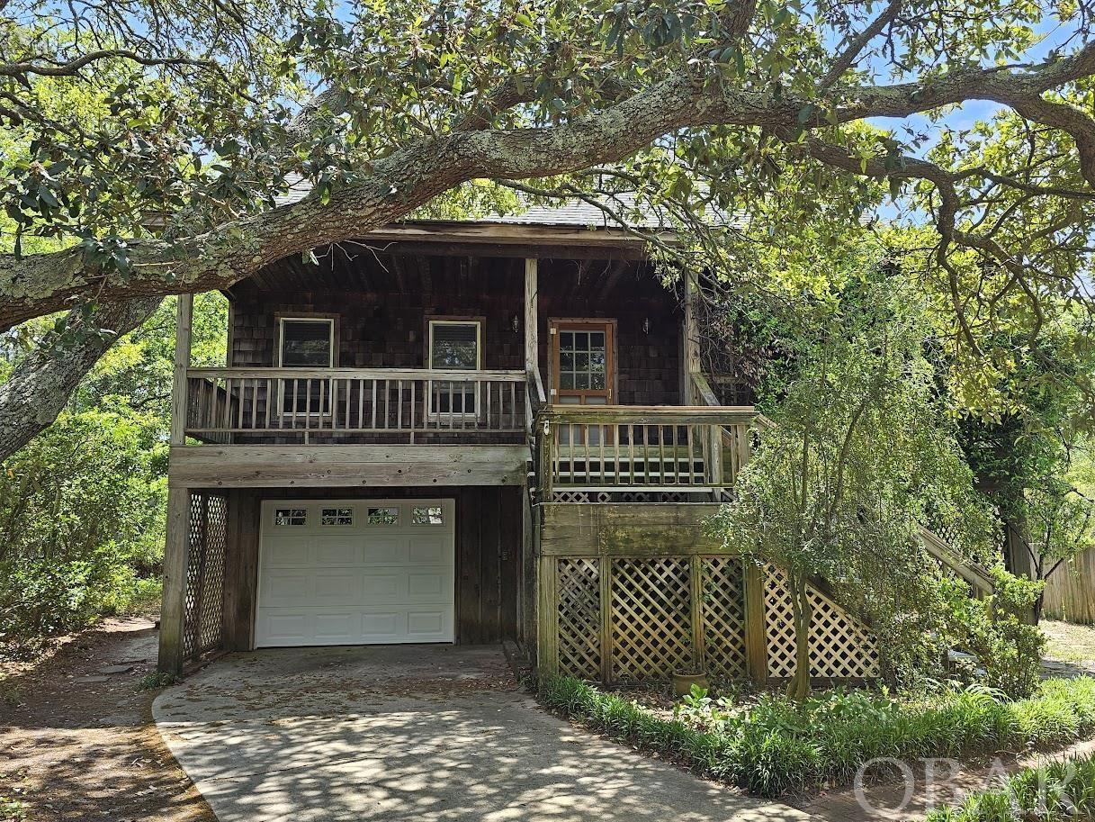Picture yourself in this home nestled under the beatiful live oak trees that front this property. Enjoy your morning coffee on the front deck made private by the jasmine winding through the corner of the deck. The large 10,500 sq ft lot allows for space for outdoor living with a backyard that is partially fenced in. Evenings can be spent out on the brick patio area with the firepit for lounging among the mature foliage. For the gardener in the family, there is an open potting shed area complete with sink and plenty of counter top workspace and storage. Don't forget the outdoor shower for easy clean up. There is a convenient dry entry into the home through the garage. In addition to the 495 sq ft garage on the ground level there is 627 sq ft of enclosed bonus space with steps leading up to the living area. Inside the home you will notice right away the beautiful white oak hardwood floors with matching stair treads to the upstairs bedrooms, custom made wooden valences thru out, recessed lightening, open living and dining area, sunroom with vaulted ceiling which leads out to the mid-level deck overlooking the backyard. Not to forget the chef in the family...check out the kitchen...custom cherry kitchen cabinets with roll-out self closing drawers, easy access to blind corners, knife drawer, spice drawer, granite counter tops, under cabinet lightening, gas stove, dishwasher and brand new refrigerator. Large laundry room with front-end wahser and dryer, has 2 closets for additional storage, closet for hot wather heater and powder room. The master bedroom with walk-in closet and 2nd bedroom round out the mid-level floor. The top floor has 2 bedrooms with Jack & Jill bath with 4 finished attic spaces in the eves allowing for additional storage space. Check out this home and property and make this special place yours...
