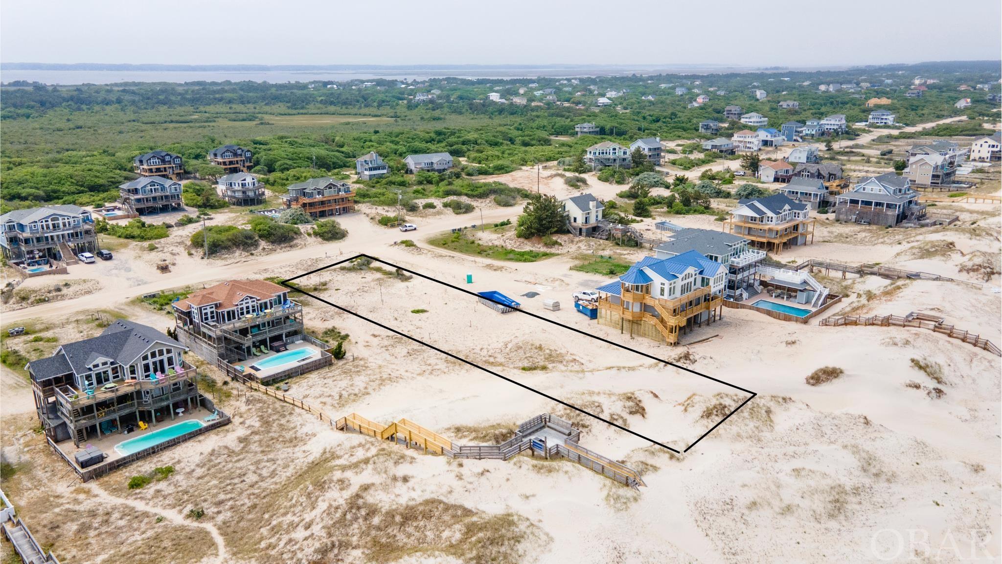 Much desired Oceanfront Lot! With 80 ft of frontage and 350 ft of depth, there is plenty of room for your perfect home design that would accommodate an amazing second home or an income producing rental property.  This fantastic lot has a strong dune to afford protection while still maintaining a nice elevation on the front buildable portion of the lot allowing for your best views. There is a 10ft easement on the South side of the lot for an additional buffer from the neighboring property. Come walk this lot today!