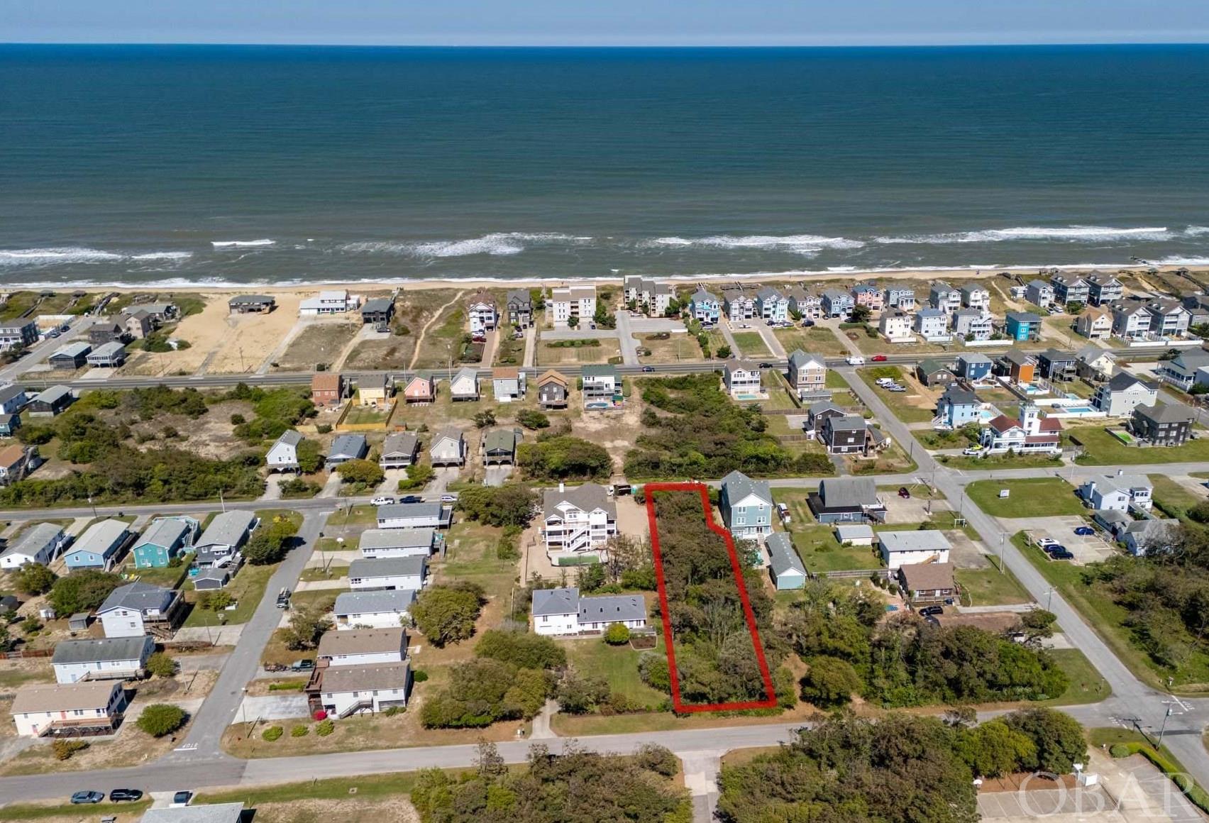 Large lot in the heart of Nags Head. This unique lot with apx 17,000 sqft offers many potential possibilities with access from Wrightsville Ave on the west side and Memorial Ave on the East side. One of the few through lots available in Nags Head, 51' road frontage on Memorial - 60' road frontage on Wrightsville. C4 zoning appears to allow many building options.  Build your dream home, second home or investment property with an ocean view. This ideal location is close to shopping, galleries, and restaurant such as Red Drum Grill and Taphouse, Mahi Mahi, Booty Treats ice cream. Located between Gallery Row and Albatross beach access.