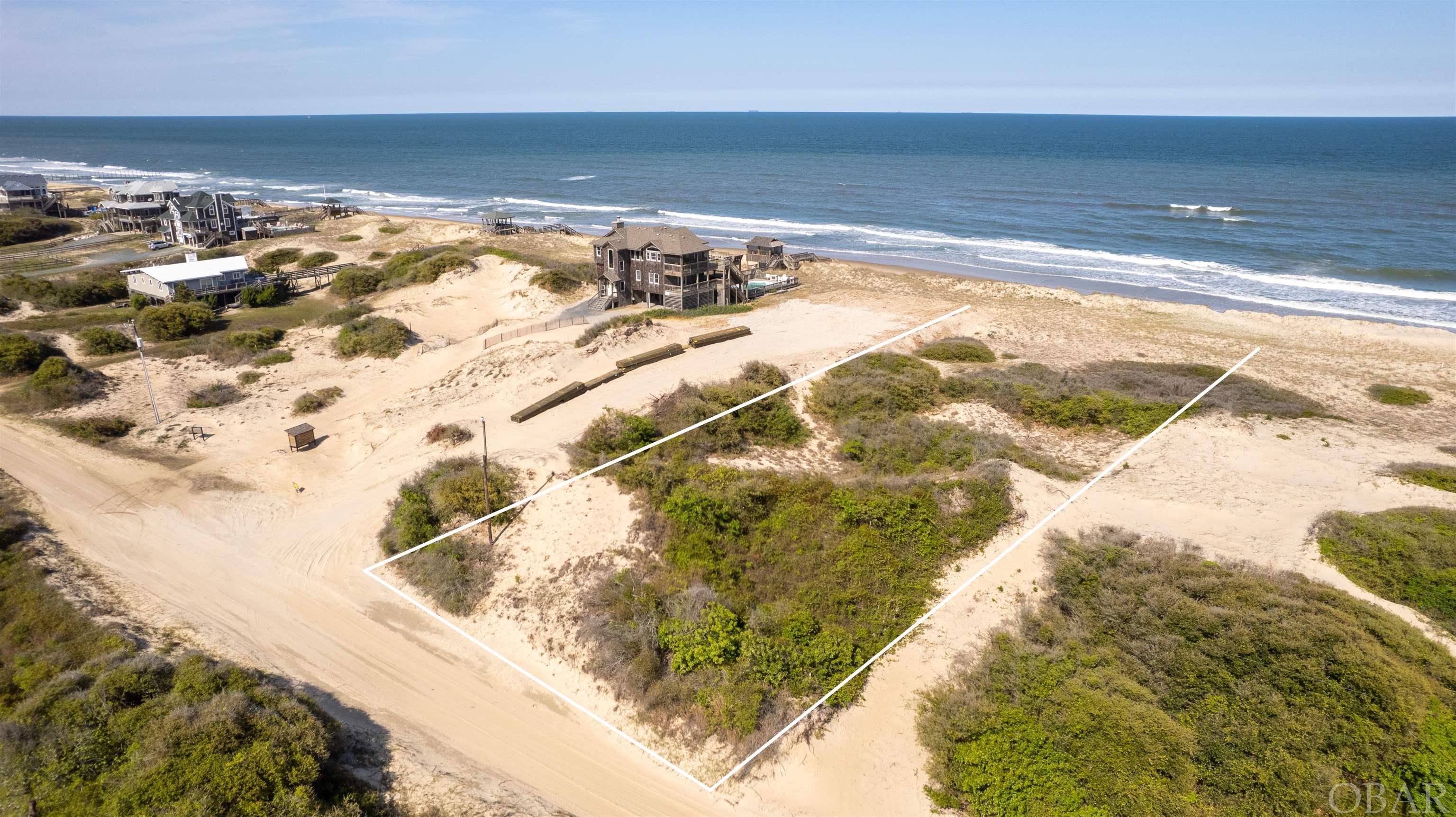 This is a must see Oceanfront property as this kind do not come on the market often. X flood zone throughout the entire buildable footprint.  HUGE elevation throughout the lot starting at the road to the primary dune which will afford a future home the extremely rare duality of sweeping ocean views AND elevated protection. The entire lot is well vegetated which stabilizes the sand in place preventing wind-driven erosion. There are only a handful of lots in Carova Beach that offer this kind of height, protection, and X flood zone. This lot would be an enviable location for a second home or a highly sought after and successful vacation rental.  Survey and soil report already completed and on file