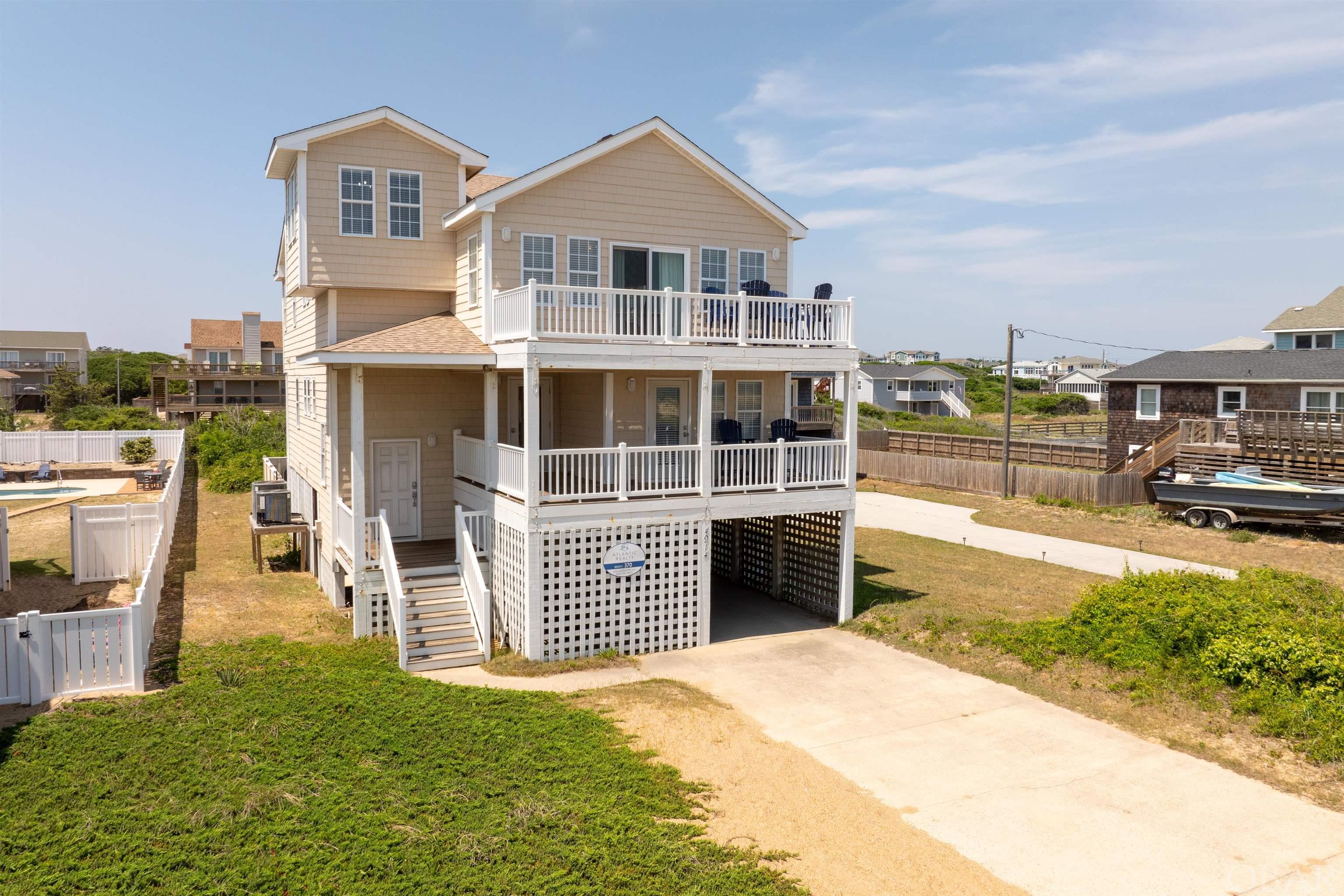 Experience luxury beach living in the heart of the Outer Banks, semi oceanfront in Kitty Hawk. This spacious and well equipped vacation rental property has all of the amenities that make for the perfect oceanside getaway. The views from the top level living area are what really makes this home spectacular. Enjoy the ocean breezes from multiple levels of spacious decks, or take a dip in the private pool after a long day at the beach. Currently a rental property, this home offers the opportunity for a new owner to have a full rental season already booked and the expected income ready to go. Additionally the home offers a recent fortified roof, HVAC updates, 2022 water heater replacement, new 7 person spa and so many other updates you can check off your list! This is a true turn key investment property and a chance to call the beach your second home away from home.
