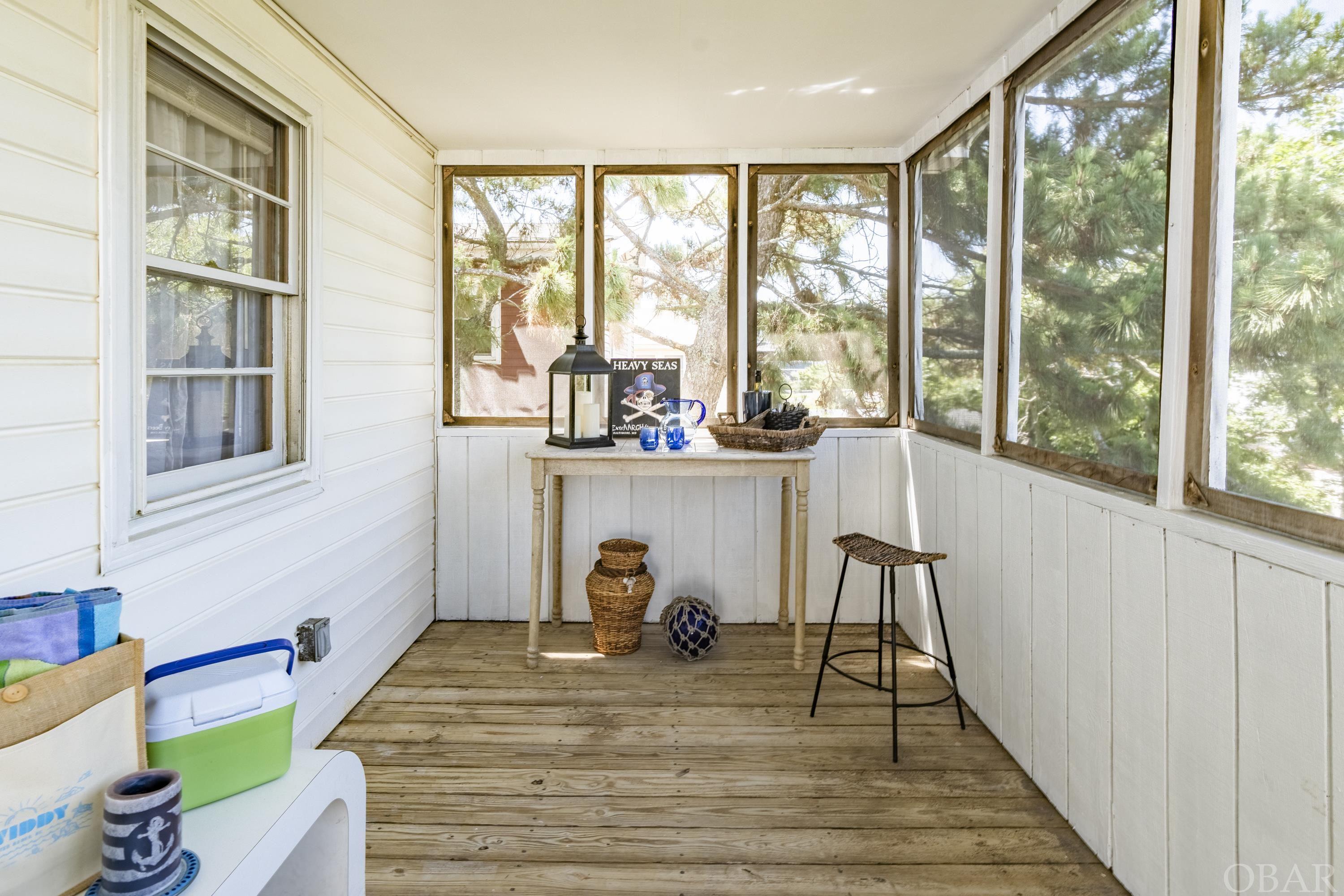 The rear screened porch is great for sharing some laughs!