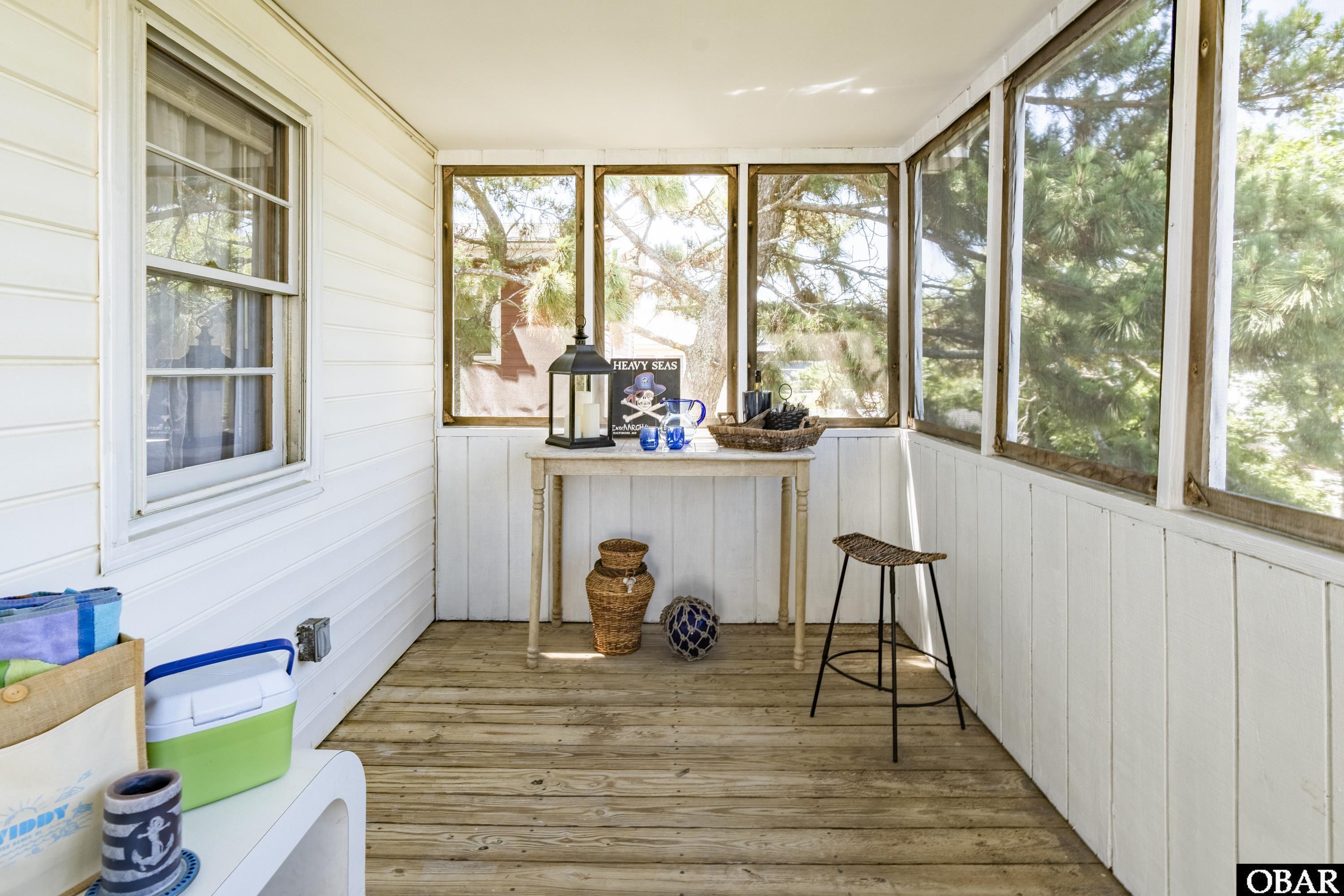 The rear screened porch is great for sharing some laughs!