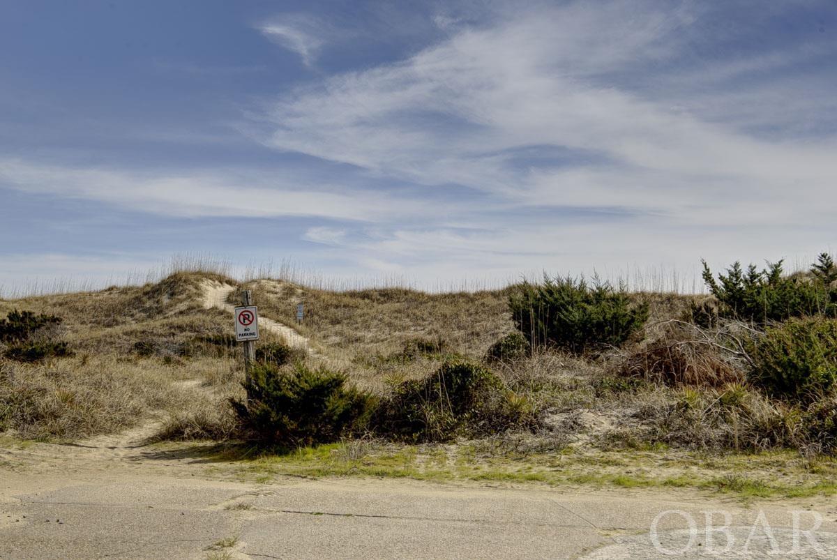 If you are considering building your oceanfront dream home, this Frisco lot deserves your consideration! Frisco beaches face south and offer and flatter beach than many other areas. It is perfect for a day on the beach of swimming, surfing, SUP, great fishing, and family fun. A home here will have excellent water views and you can watch the sunrise from the east. Billy Mitchell Airport and Road are just minutes  away and offers access to the beach with a 4 wheel drive to Ramp 49. Whether you are seeking a personal sanctuary or a great parcel for an investment home, this could be the paradise you have been looking for. The adjacent oceanfront lot is also for sale for unlimited opportunities!
