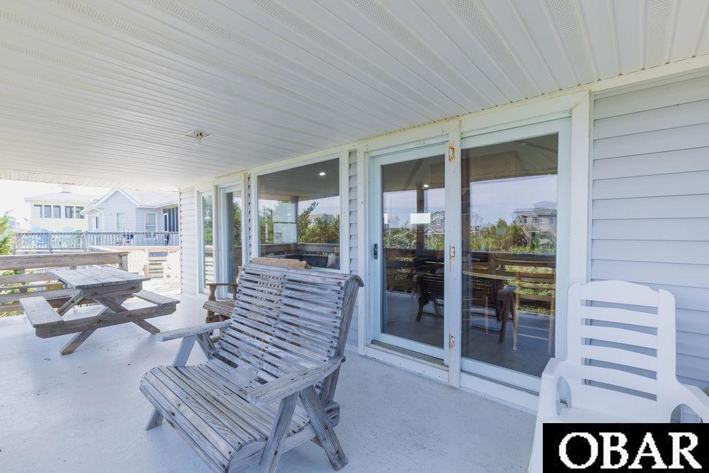 Covered porch off main living floor.  Access from living and dining rooms.