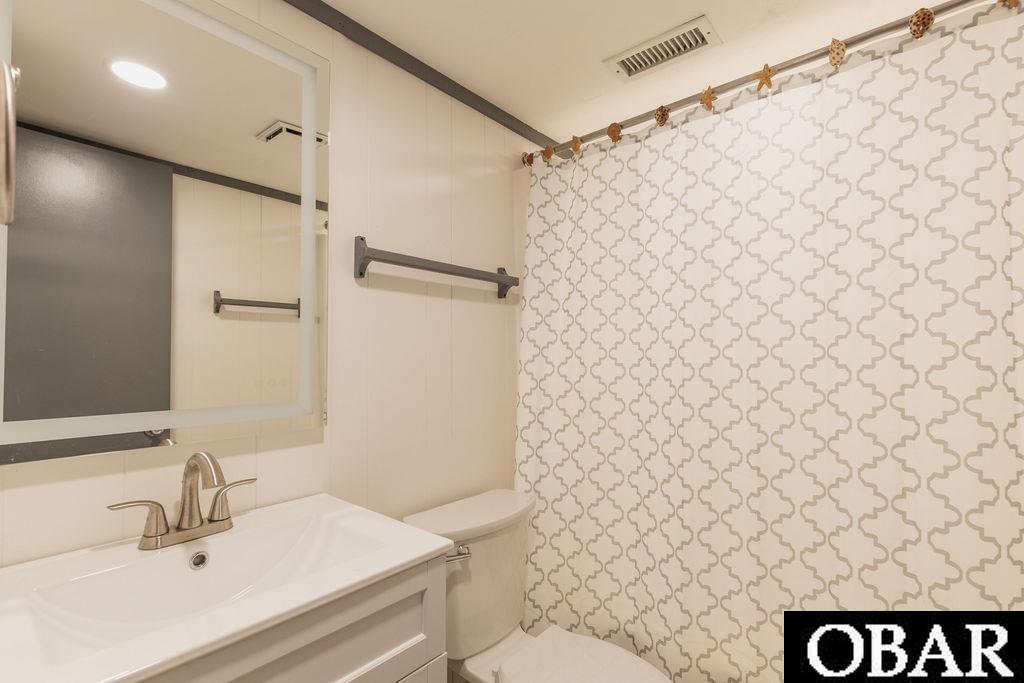 1st level hall bathroom.  New flooring, fixtures, vanity, toilet and lighting.