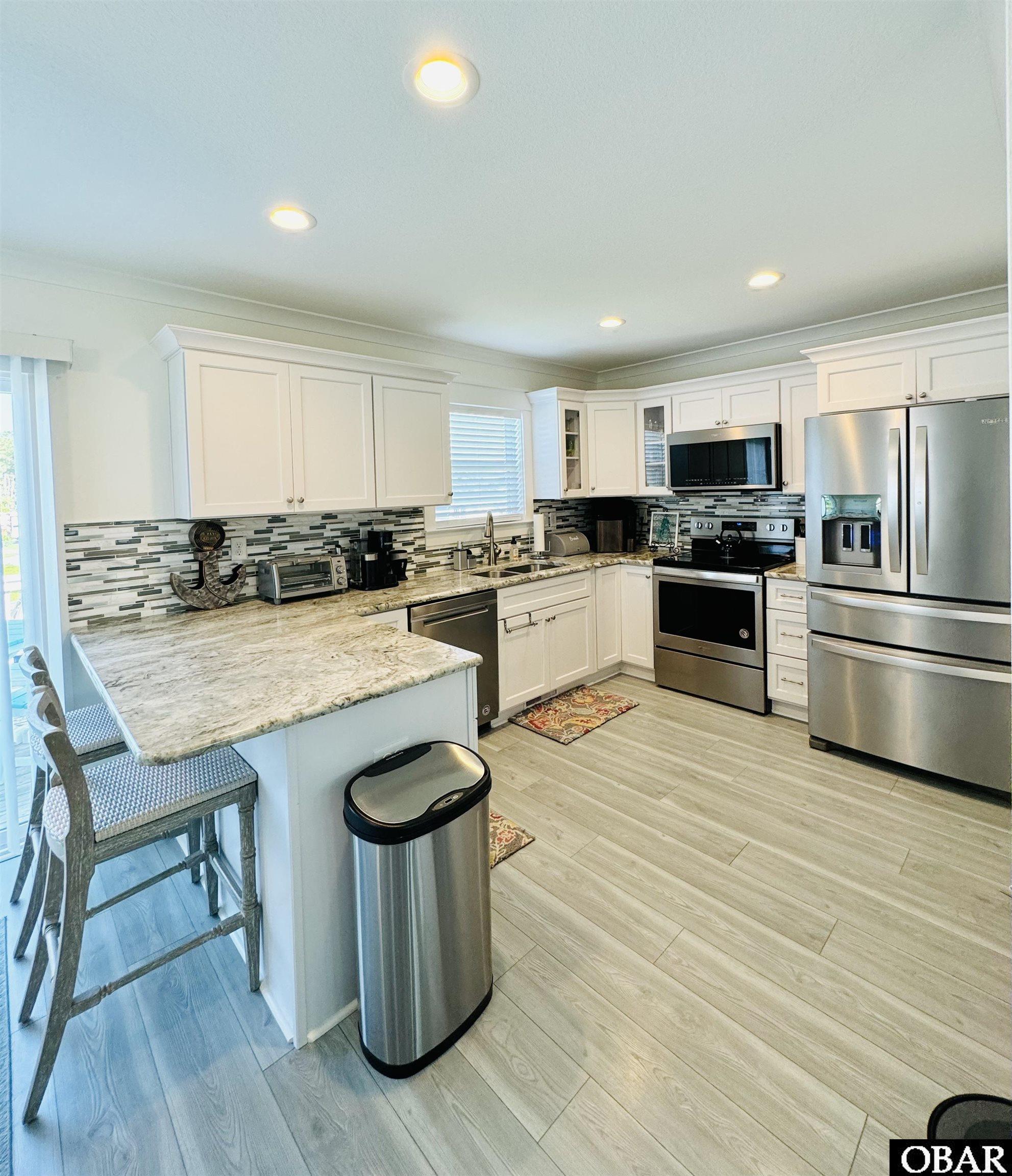 Hard Surface counter tops, luxury vinyl plank, stainless appliances, eat at bar and breakfast nook, and pantry!