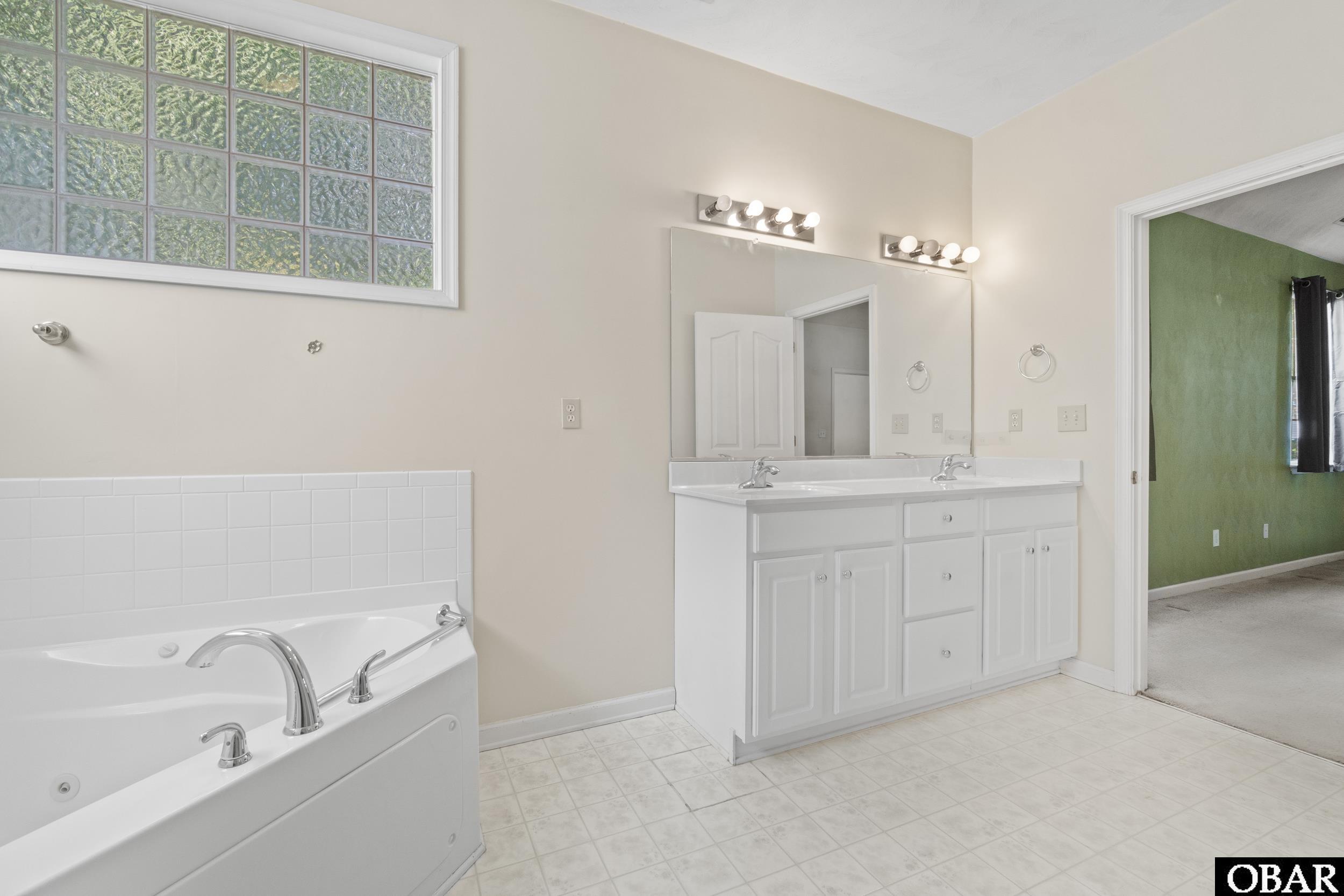 Primary Suite with double vanity, soaking tub and separate shower
