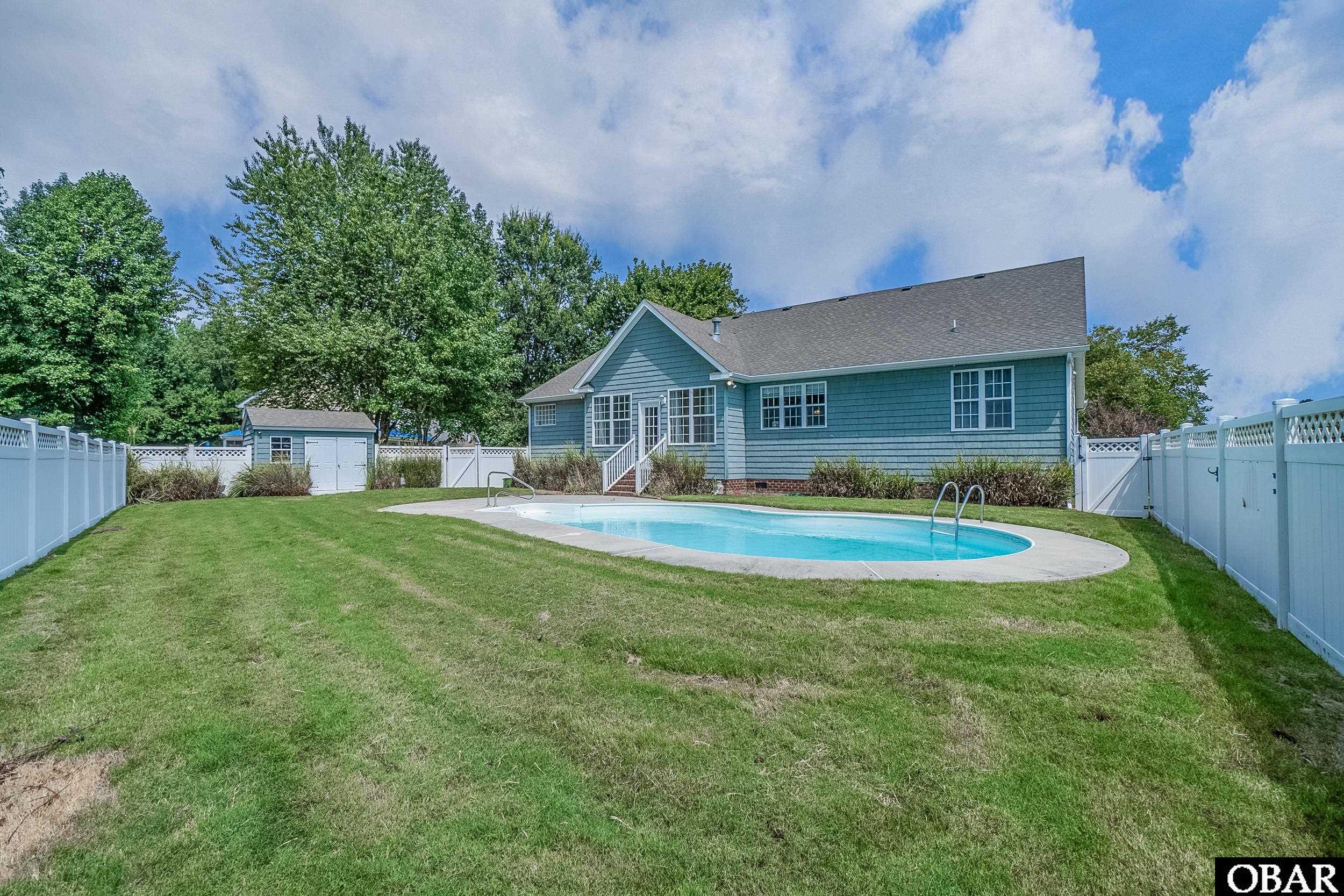 Inground pool with fenced backyard