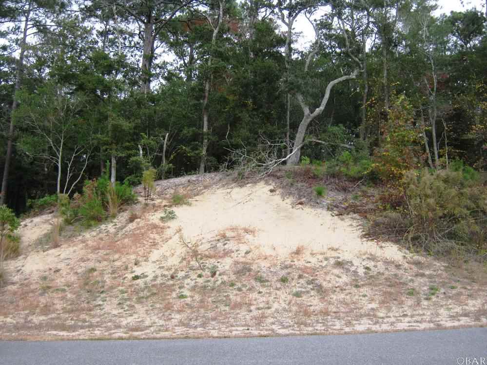 Large, wooded and highly elevated on a ridge-this homesite is in a Cul-de-Sac and in an exclusive soundside community consisting of 73 homesites with high elevations.  It has a sandy beach and expansive views of the Albemarle Sound. Close to schools, dining, shopping and Outer Banks activities.  Over 45% of the property will be left as a nature reserve, permanently conveyed.