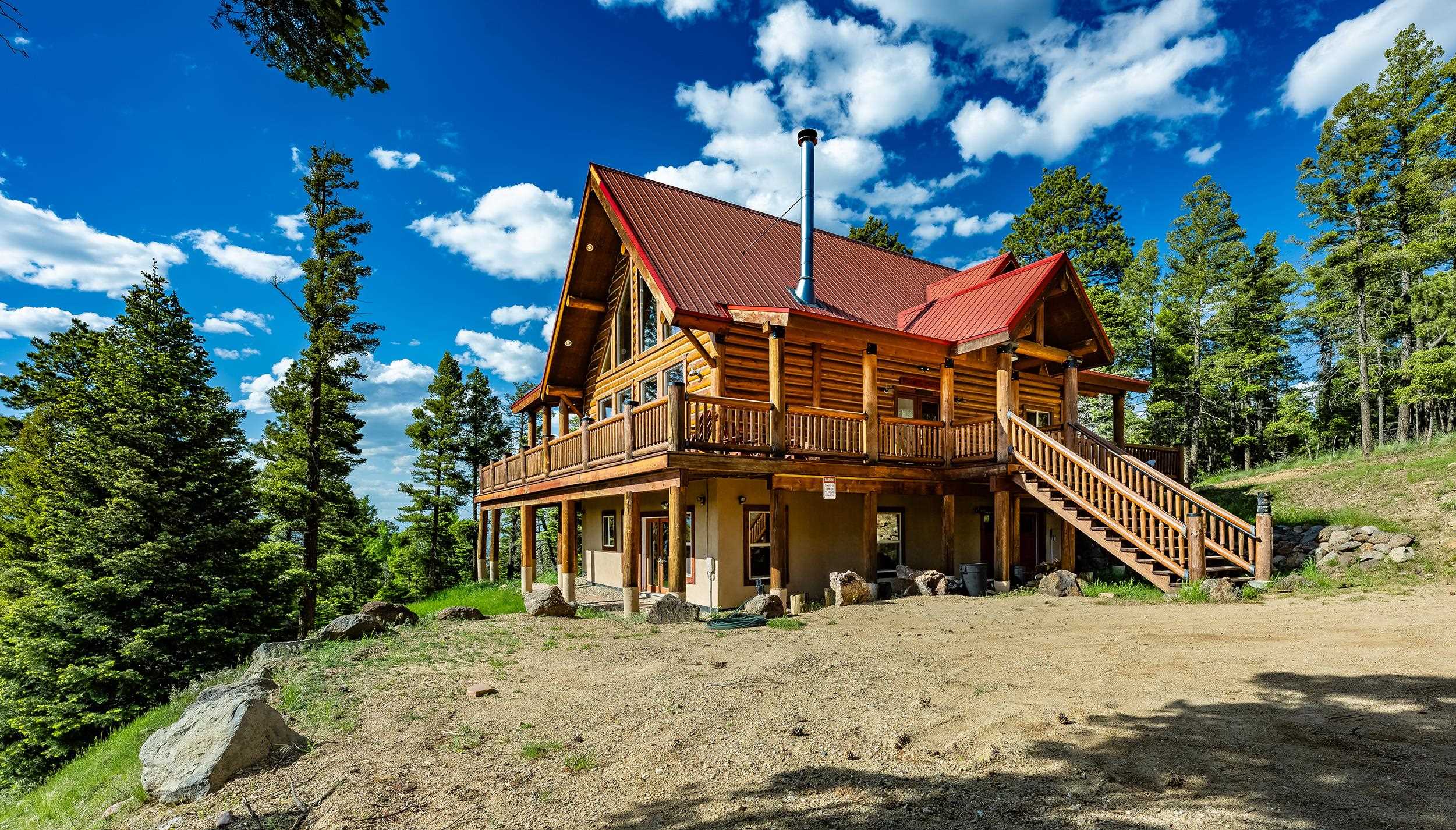 SKI IN/SKI Out Dream Home ! Imagine yourself sitting in the hot tub watching skiers come by through the trees and enjoying an apres ski hot toddy. Life is good in this mountain home just steps off the ski area.  One of the closest ski in/ski out houses to the Angel Fire Ski Area. The home sits on approx 1.92 acres and has amaizing views off the southwest side of the property and views of ski run on the northern side.  5 bedrooms, 4.5 baths with two living areas, two full kitchens as well as two laundry areas. If you are a skier or a Mountain biker it doesn't get much better than this.  Potential for rental is high. Angel Fire Resort Amenities package is part of your membership.  You and your immediate family will enjoy ski passes,  country club access, golfing in the Summer and more ( rules and regs apply to membership).