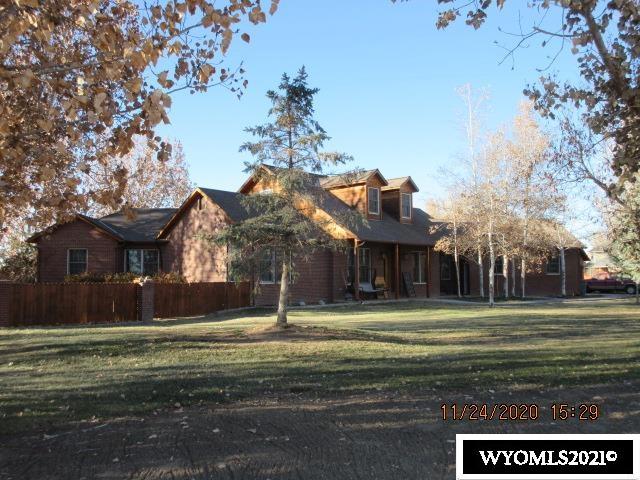 Watch the sunrise in the morning and the deer in the evening in this beautiful home in Worland's Ponderosa Estates. Large open living area is complemented with a rock fireplace and wood floors. A mother-in-law suite sits off the kitchen for when guests come to visit. A den or office helps keep that computer gamer or workaholic busy. The main bedroom is large and its own bathroom. A large bonus room upstairs could be turned into another bedroom or just keep it as a space for the kids to escape. There is space to store your toys in the two garages. A covered hot tub and back yard deck make this a great place to entertain family and friends. The yard is fenced  and has room for a garden or sports courts. Make this your next home.