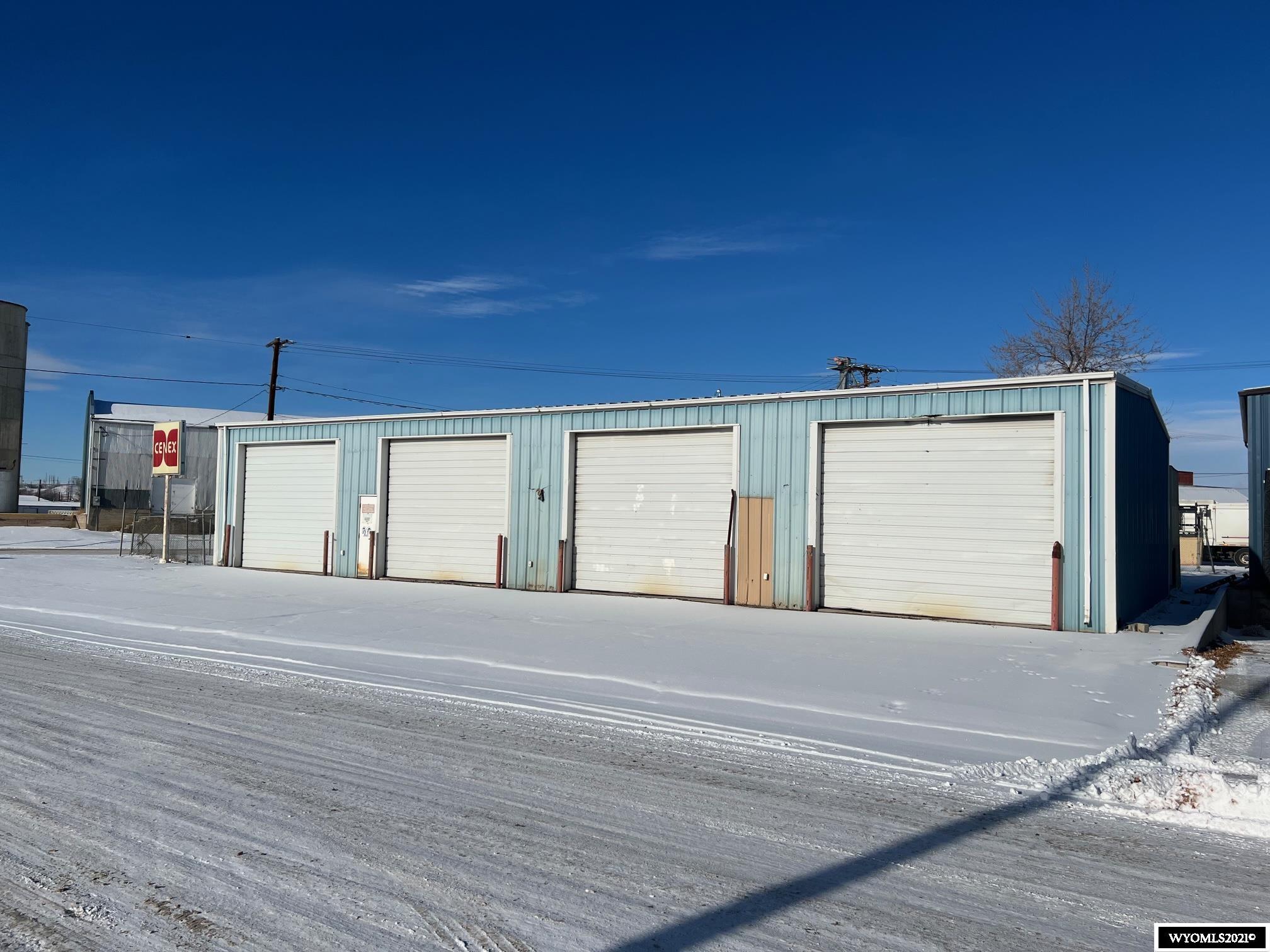 Two commercial properties being sold together.  One lot (0.3 acres) has heated 4-bay shop with office, restroom, and loft, as well as two additional storage buildings.  Other vacant lot (0.61 acres) directly across the street could be used for parking or is a blank slate for a new commercial building.  Zoned light industrial.