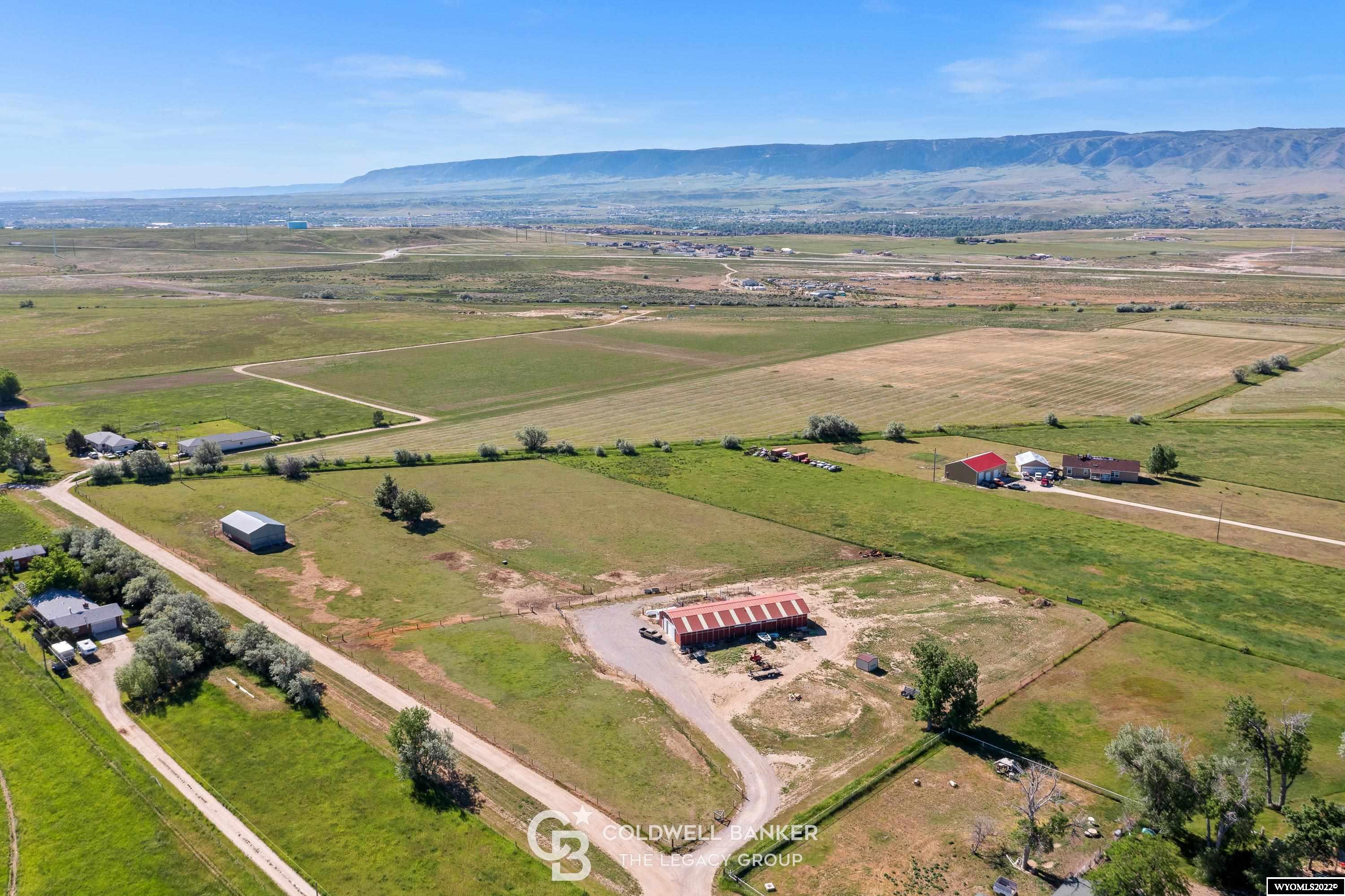 This property is in a superb location, excellent condition, and has enormous potential!  An exquisite building site located near town with expansive mountain views and privacy from any neighbors.  The parcel is currently under center pivot irrigation producing grass and alfalfa hay.  The 42'x108' barn features 8 fully equipped horse stalls, two hay lofts, and a large tack room.  The property could also be developed into separate residential lots and has 4 water taps available.  Call Quinn at 307.399.0744