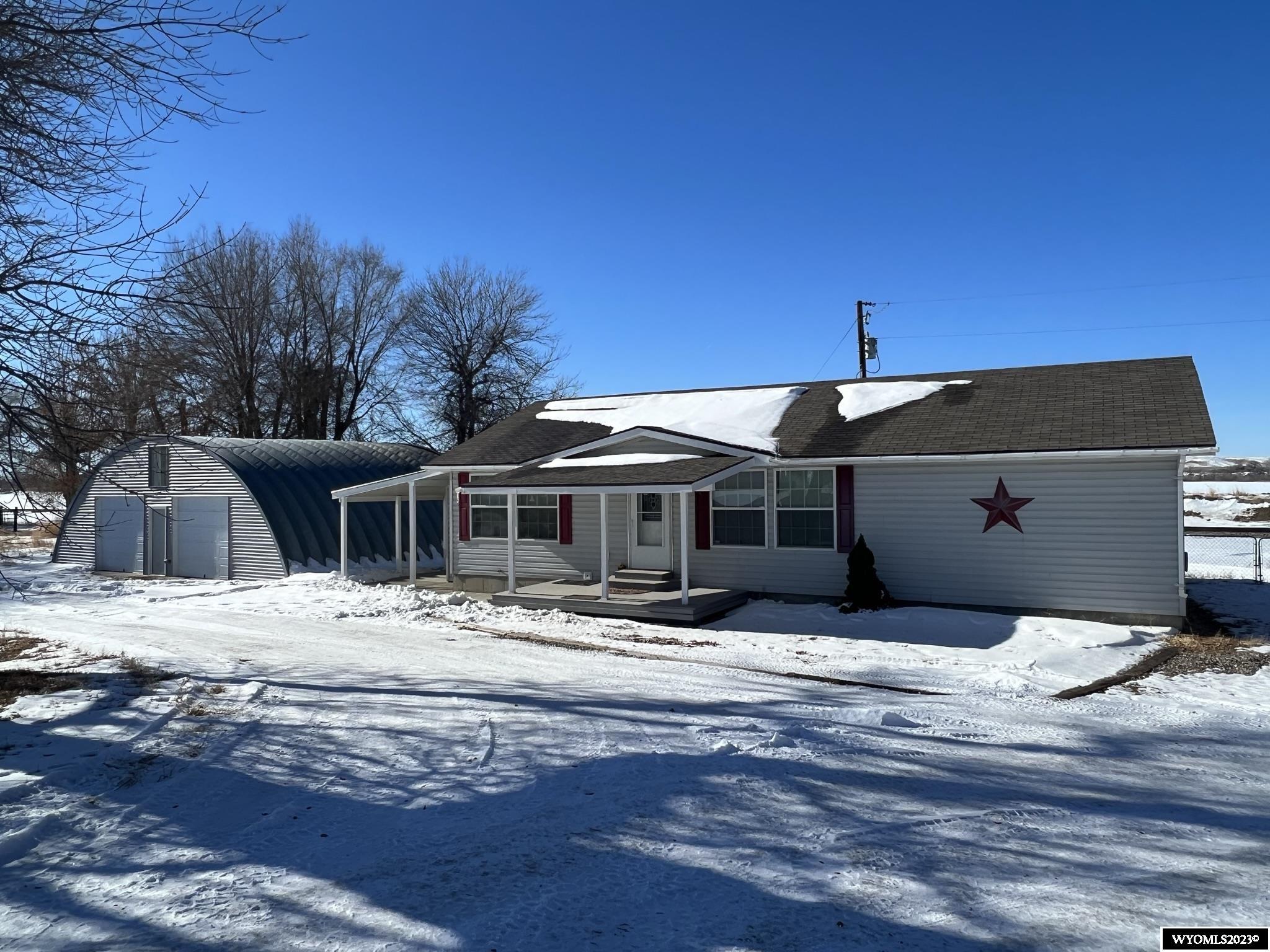 Very nice modular home on a permanent concrete foundation with full basement, on a large rural lot.  Home boasts an open kitchen/living room layout with convenient access to the laundry/mud room.  Primary bedroom with ensuite bath, and two additional bedrooms and full bath on main.  Basement has one room finished as a bedroom - the rest is a blank slate to make it fit your needs!  Basement can be accessed from interior or exterior of the home. The outside space provides for lots of options - relax on the covered composite deck or concrete patio, tinker in the 1320-square foot Quanset shop, or tend to critters in the corral/loafing shed.  Endless possibilities await the new homeowner!  Quonset building sustained previous damage from a fire that originated from a heat lamp in the wood structure behind the building. The building has been restored with new electrical, siding, and garage doors.