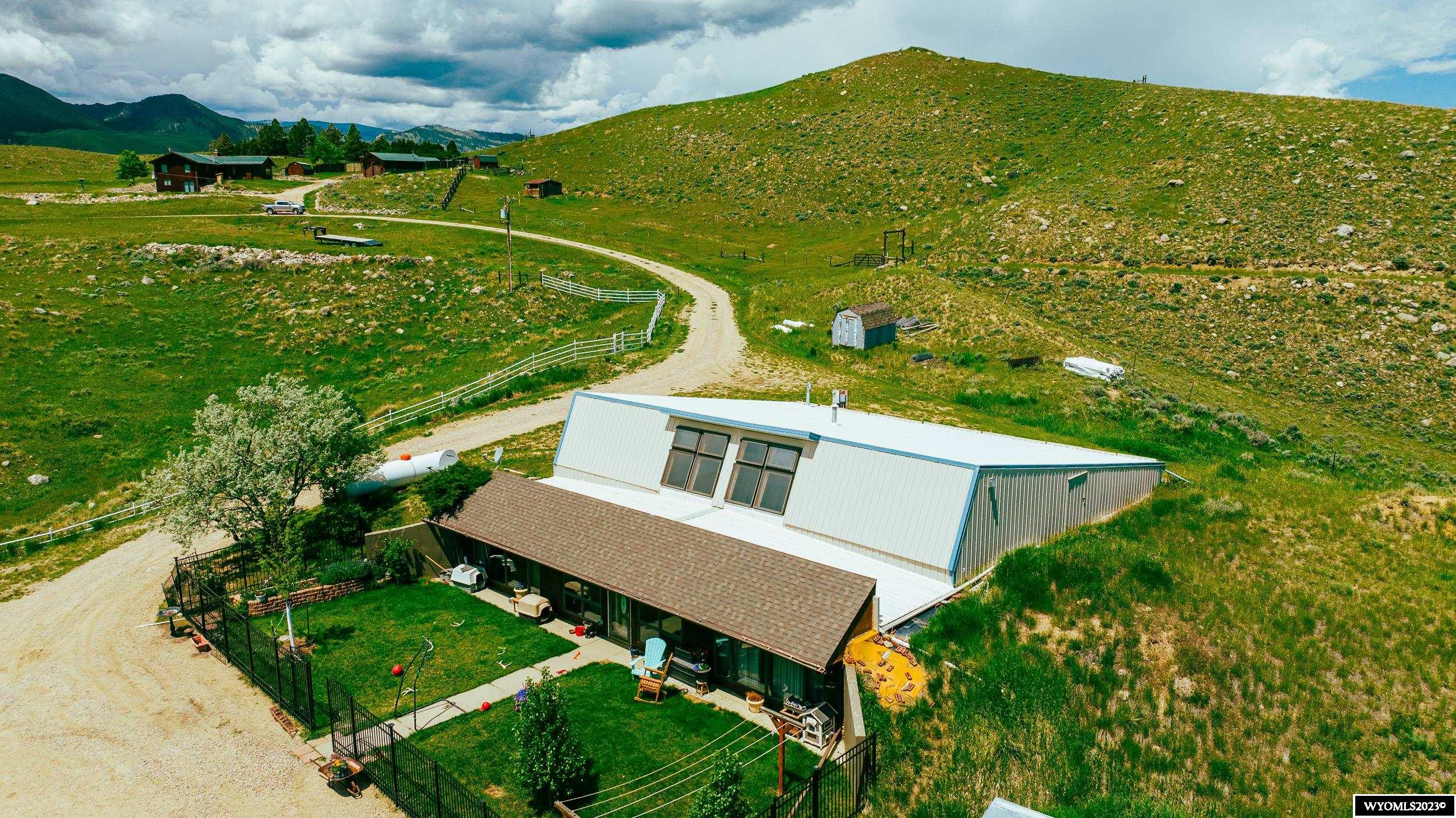 Beautiful solar home w/ app. 3132 sq. ft. of living space in the country with breath taking views of the Bighorn Mountains & valleys.  This home has 3 bedrooms & 1.5 baths. Large master bedroom suite w/ a 1/2 bath but the drain is there to add a shower if you wish. Large sun room to grow your vegetables & plants. Large spacious kitchen w/dining area. Formal living room, separate office or family room area. Utilities run next to nothing due to the solar design. Access to 3000 plus square ft. of storage above main floor of the home with outside access. Wrought iron fenced in yard in front that is well landscaped. Small reservoir on the property  below the house.  End of the road and private location.  Antique medicine cabinet in the master bath does not stay with the sale of the property.  Stop by and view this home with Cristy Kinghorn 307-620-0037  Seller would sell up to 138 acres separately for $5000 an acre. House and approximately 15.66 acres can be priced separately.