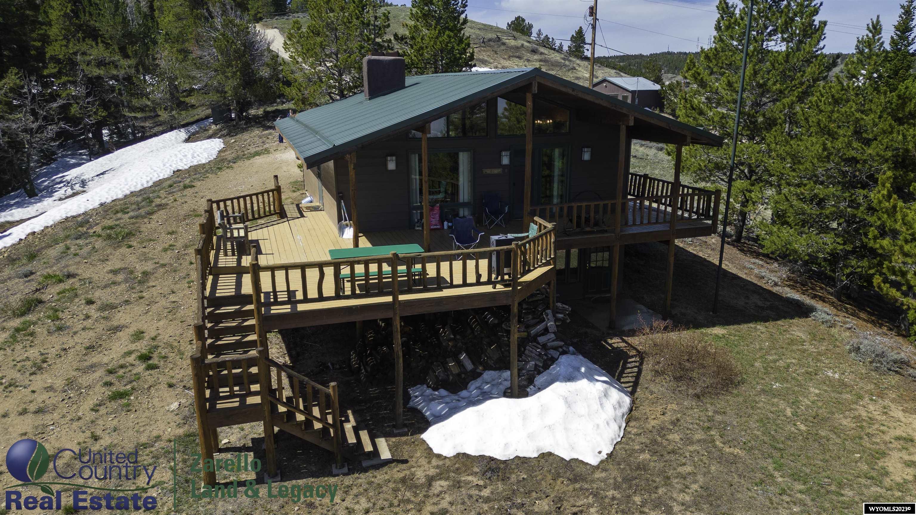 United Country Real Estate | Zarello Land & Legacy are proud to offer for sale this sprawling Casper Mountain Retreat! Nestled on over 140 acres of picturesque mountain terrain, this stunning cabin offers an unparalleled opportunity to embrace the essence of Wyoming living. Located adjacent to the renowned Hogadon Ski Resort, this property offers up some breathtaking city views of Casper, Wyoming.  As you step inside, you'll be greeted by the warmth and charm of this fully furnished cabin. With three spacious bedrooms and two bathrooms, there's ample space to accommodate family and friends. The rustic yet elegant interior design creates a cozy ambiance, allowing you to unwind and enjoy the serene surroundings.  Imagine waking up to the soft rays of sunlight streaming through the windows. The open living area features large windows that frame the panoramic vistas, offering a seamless integration between the interior and the natural beauty of the outdoors. A crackling fireplace invites you to gather around, creating an inviting atmosphere during chilly winter evenings.  The cabin also features a two-car detached garage, providing ample storage for your vehicles and outdoor equipment. Whether you're an avid skier or simply enjoy exploring the rugged wilderness, this property offers the perfect starting point for your outdoor adventures.  Indulge in the ultimate relaxation experience with your very own indoor sauna. After a day of exploring the slopes or hiking through the pristine forests, unwind and rejuvenate your body and mind in the tranquil sauna. It's a true haven for relaxation and well-being.  One of the highlights of this property is its self-sufficiency. With a private well and septic system, you can enjoy the benefits of mountain living while still having the conveniences of modern living. Embrace the peace and serenity of the mountains, knowing that you have all the essentials to create a comfortable lifestyle.  Outside, the sprawling 140+/- acres of land are yours to explore. Picture yourself strolling through the open meadows, listening to the gentle breeze through the trees, and the sweet melodies of birdsong. Whether you're an outdoor enthusiast, a nature lover, or seeking a peaceful retreat, this property offers endless possibilities.  Don't miss this once-in-a-lifetime opportunity to own a piece of Casper Mountain. Immerse yourself in the tranquility, beauty, and outdoor adventures that await you. Contact Derek or Jennifer Zarello at 307.337.9282 today to schedule a private viewing and start your journey towards a life of mountain living at its finest!