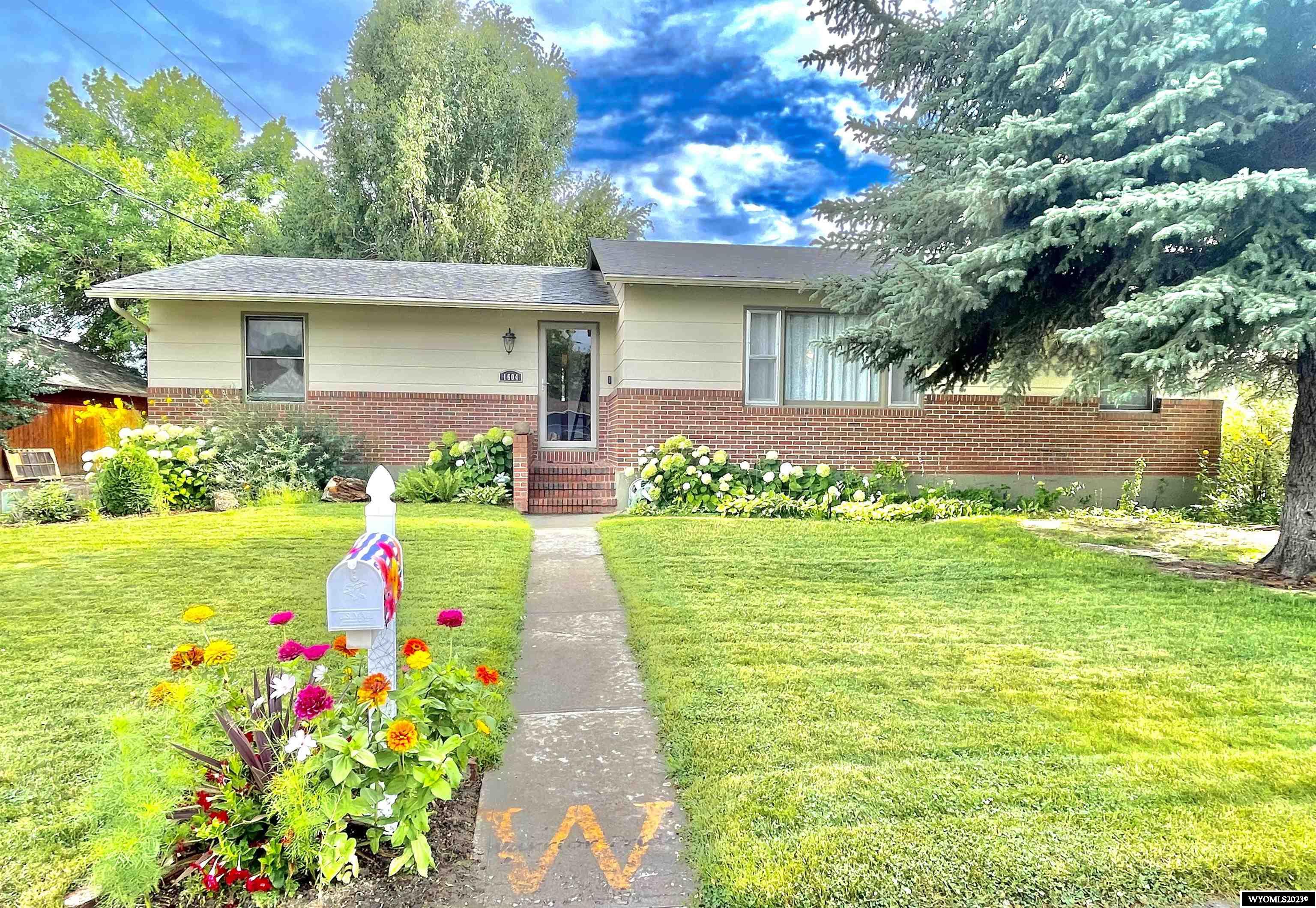 BEAUTIFULLY APPOINTED GEM that is a must see!   This gorgeous home has many updates throughout with 3 living areas and 5 bedrooms (2 upstairs, 3 downstairs); two basement bedrooms with newer egress windows.    Back living area has a gas fireplace with a handsome brick surround in addition to large windows that give an abundance of natural light.    Covered patio out the back door provides intimate space to enjoy the summer evenings. The front yard has a beautiful perennial garden.   The fenced backyard is ready for your fur babies with a pen and doggie door access into the garage kennel.    The yard has mature burning bushes, lilacs, and a birch tree all with an automatic sprinkler system.   There is even a clothes line in the backyard to add to the charm of this lovely home.   Oversized single car garage, with room to add a carport or another stall should you so desire;   a new garage door installed in 2021.  New exterior paint in 2021, main floor bathroom has new tub and tile in 2022,  new kitchen laminate installed in 2016, fully remodeled kitchen in 2011, roof installed in 2013 (with 50 year guarantee), full basement remodel in 2009, new carpet and flooring upstairs in 2018, some newer windows.