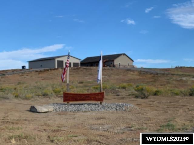 A dream home surrounded by farm land and majestic scenery is available only 45 minutes from Cody, Wyoming. The cowboy-comfortable living room boasts elk-horn light fixtures, cedar-lined walls, a native brick fireplace and built-in walnut bookcase. The country kitchen is surrounded by alder-wood cabinets and glistening southern pine countertops gently lit by canned lights. An RO water system, instant hot water tank, pantry and newer appliances (gas stove,double oven,dishwasher,microwave) complete this chef's dream kitchen. The master suite has a huge his-and-her walk-in closet along with a rock-lined shower in the master bath surrounded by glowing cedar-wood cabinetry and countertops. Two additional large bedrooms and accommodating closets are separated by a full bath. The laundry room, with ample space and newer washer & dryer, is next to a small office lined with cypress-wood walls and cedar bookshelves and trim. This luxury home boasts a covered back deck with a cedar swing to relax in as you listen to the Wyoming quiet. There is also a 2400 sq. foot shop with cabinets that stay, 220 electricity, R-19, insulation and LED lights, along with two 8-foot and one 10 foot automatic doors, all of this sitting on 10.27 acres of good old Wyoming views.