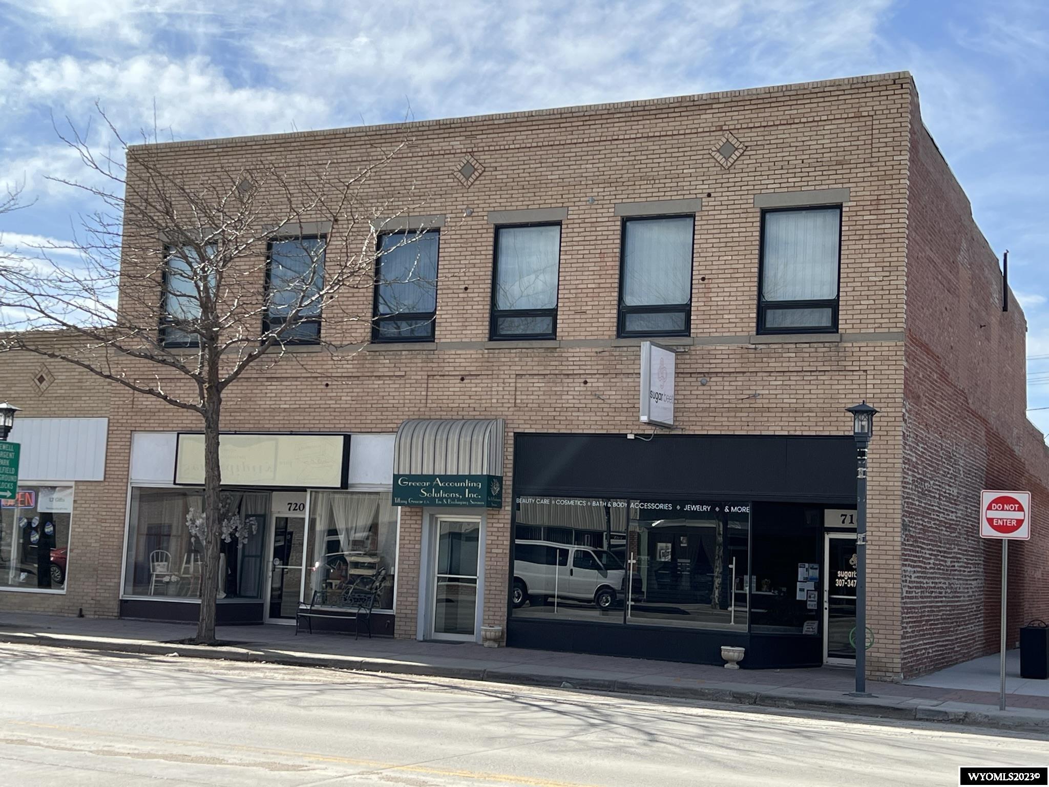Don't miss your chance to own one of Worland's original downtown buildings!  This one has it all - so many possibilities!  It is a large building and is separated into three "units", two on the main level and one upstairs.  The east main level unit consists of retail space in the front, a restroom, and additional large room. The west main level unit is currently a salon with an office, 3 rooms currently used for aesthetic services/nails, 3 rooms currently used for tanning, and kitchen/prep area.  There is a separate restroom near the tanning rooms, a "break room", an additional restroom in the back, a laundry room, and a storage room.  The rear space of the building on the main level is open and has a separate walk-through door.  The upstairs space consists of multiple large offices and conference rooms, a  kitchen/break room, and separate restrooms.  It is conveniently accessed through its own front door where customers can take the stairs or utilize the fully operational elevator (certifications will need to be brought current).  Heat on main level is provided with a combination of radiant gas and baseboard electric. .  Roof HVAC units provide heat and A/C to upstairs, and A/C to retail spaces on main level.