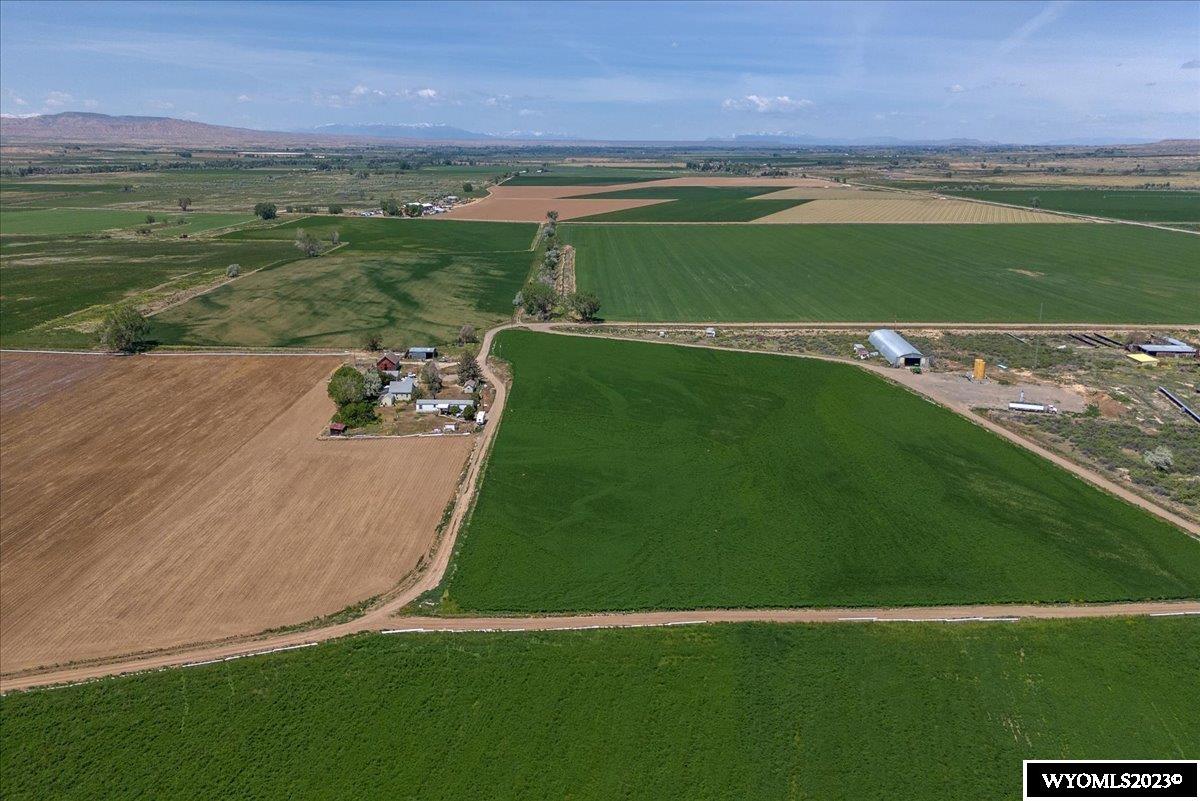 Bullinger Farms is a large, very well-maintained ag operation. Bullinger Farms is currently leased and being operated as a large productive farm with a year-round permitted feedlot having the capability to feed approximately 5,600 head of cattle.   The feedlot is roughly 36± acres and was built solidly with concrete feed alleys and 2 7/8 pipe posts, which are also set in concrete. Its water source is a 40-ft well.The feedlot includes a Silencer squeeze chute as well as a state certified livestock scale. The farm recently added 2 new Sukup gain bins, making a total of five. This improvement created an overall capacity to manage up to 122,000 bushels of grain. The farm acclaims approximately 1,878± irrigated acres growing a productive multitude of crops including alfalfa, corn, sugar beets & barley. It has excellent water rights from the Greybull River, which is delivered through 3 separate canals. The farm also has a substantial amount of reservoir water.  Eight newer Reinke center pivots irrigate 1000± acres. The pivots range in size from 100 to 178 acres. Approximately 1,250± acres are flood irrigated with concrete ditches & siphon tubes in addition to gated pipe. Almost all of the gated pipe is fed through underground lines with risers and valves. Water right information is available upon request from McGarvin & Taylor Real Estate. Please note - seller would consider dividing parcels.  Contact McGarvin & Taylor Real Estate for more information.