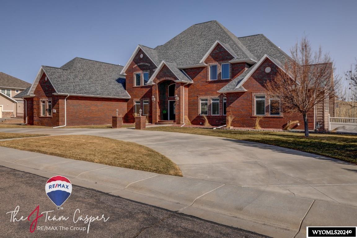This exceptional custom home boasts an enviable east-side location! Featuring a spacious open floorplan, it offers a separate living room and family room, a finished walk-out basement, and dual kitchens. Step out onto the expansive deck to soak in views of Elkhorn Creek and Casper Mountain, ideal for hosting gatherings. The luxurious primary suite boasts a gas fireplace and a generously sized, well-appointed master bath. Situated on over half an acre, the fully landscaped lot boasts a terraced design,providing numerous outdoor spaces to relax, including a private hot tub with serene vistas of the designated green space behind the home, ensuring ultimate privacy. With five bedrooms, each accompanied by its own private en suite bathroom, plus two half baths for guests, this home offers ample accommodation. Enjoy the convenience of a main floor office with built in desk and picturesque views of the green space. The main level deck is perfect for entertaining, while the large chef's kitchen is equipped with commercial-grade appliances, complemented by a butler's pantry and a spacious laundry room offering ample storage. Schedule your private tour with Jennifer Gladson of J Team RE/MAX the Group today at 307-259-5074.