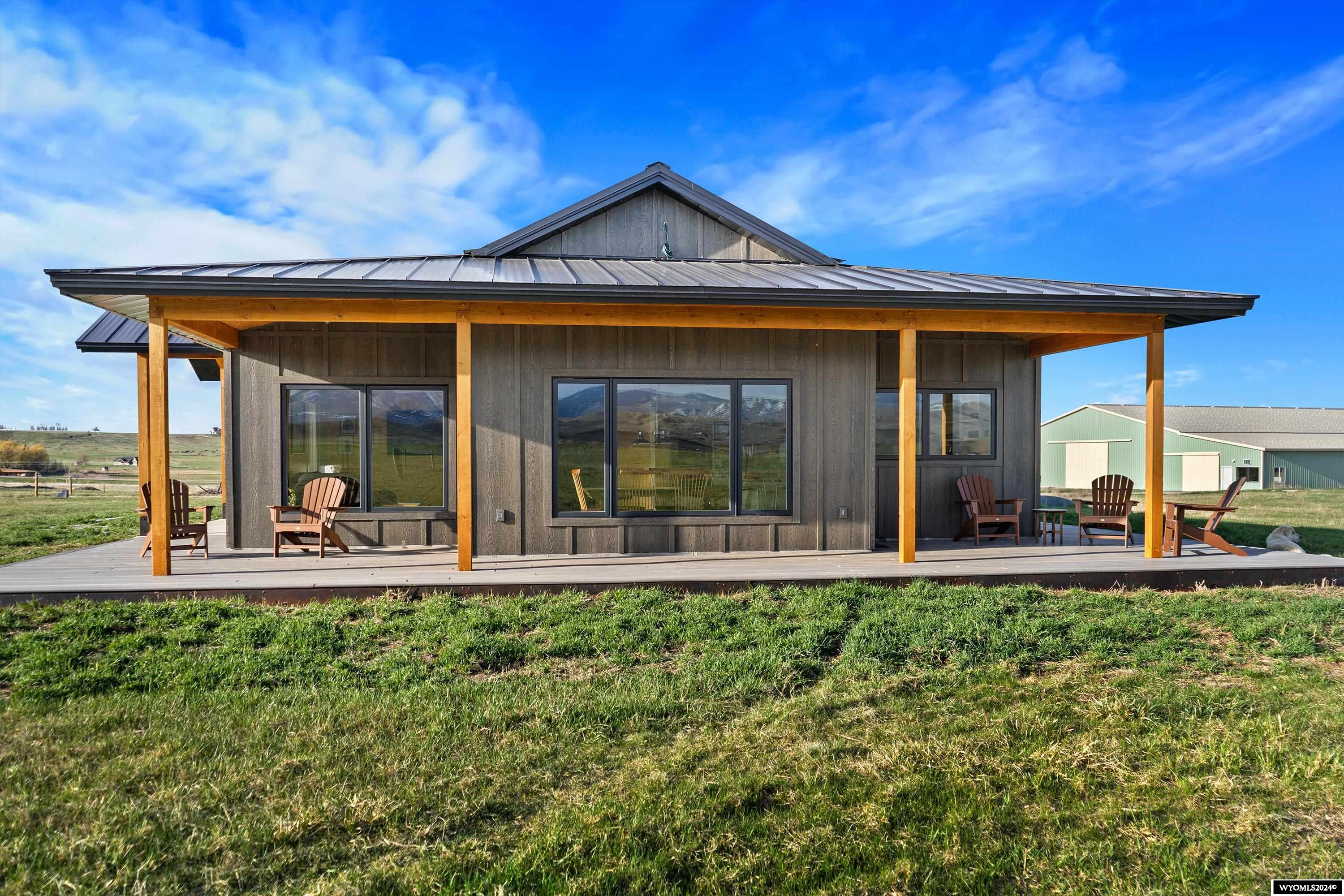 Golden Willow Haven is the quintessential Wyoming horse property. Features include a custom home, 160 x 98 indoor riding arena, 2 loafing sheds with automatic waterers, irrigation, and abundant mountain views in every direction. It is approximately 14.79 acres sitting on the bench above Lander Wyoming, conveniently located just outside the city limits. Amazing care and attention to detail were taken in the design and layout of the home, arena, and property.The home is an oversized 2 bedrooms and 2 bathrooms with an attached 3 car garage. Inside you will find a generous living area coupled with a gorgeous custom kitchen featuring granite countertops and Wolf and Sub-Zero appliances. A dining area offers views second to none in the valley. Passing to the two back bedrooms you’ll traverse a short corridor with a built-in office space containing ample room for two workspaces and entrances to a convenient pantry and second bathroom. Resting between the two back bedrooms is a convenient laundry room with built in wash tub and folding benches. This acts as a mud room and access to the oversized three car garage. The guest bedroom is situated on the west side of the home and has a large picture window for enjoying the amazing sunsets on the Wind River range. A master suite should feel luxurious and this home’s does not disappoint. The warmth of the in-floor heat rises up to meet you in the morning as you awake with the sun out a large east-facing window. The deep walk-in closet is well designed and conveniently located nearest the laundry room. A built-in soaking tub is adjacent to a curb-less, walk-in tile, shower and accompanied by a granite vanity.   Built with incredible craftsmanship and foresight both inside and out, this home features hydronic in-floor heat, air conditioning through exposed ducting in vaulted ceilings, stained and polished concrete floors, a whole home Bluetooth stereo system, and has been prewired for satellite dish or internet. The home is supplied water by two 3000 gal cisterns. Both the home and barn have separate septic systems.  14.79 acres of fertile soil with irrigation rights to the majority of the property, grows a very healthy stand of grass through the summer and makes excellent pasture. Electric fencing is offset from the perimeter and has multiple cross fences for paddocks or rotational grazing.  The property sits on an unassuming plateau looking down on the outskirts of Lander. Unlimited mountain views abound in every direction. Property with this amount of seclusion and close proximity to town are extraordinarily rare in the Lander Valley. The terrain is mostly flat and the parcel is situated and has adequate length that it would be quite convenient to put in a private air strip as well.   An oversized heated 3 car garage was built in accordance with the lifestyle of the property. Each bay can easily house a full-size dual wheel pickup with ample room for storage. The garage is heated with hydronic in-floor heat and one bay is prewired for an electric vehicle charging station.  Approximate size is 28 x 36 feet. To those with horses a barn is often as important as the home, and at Golden Willow Haven it shows. The facility features a 160 x 72-foot arena with slanted kick boards, rubber mulch footing, and a full assortment of jumps, rails, and obstacles. The size is generous for most equestrian disciplines and perfect for 20-meter circles. An Approximately 26-foot-wide section along the arena includes a 1 bed 1 bath apartment, alleyway, tack room, restroom, 2 saddling bays, storage and ample room for covered hay storage. With a building of this size and quality, usage possibilities outside the scope of an arena are endless as well. The barn would be suited as a large hangar for a private airstrip, equipment storage, a mechanic’s shop, a dance studio, or anything else an owner can imagine. The 1 bed 1 bath apartment was recently finished inside and would make a terrific manager’s apartment.