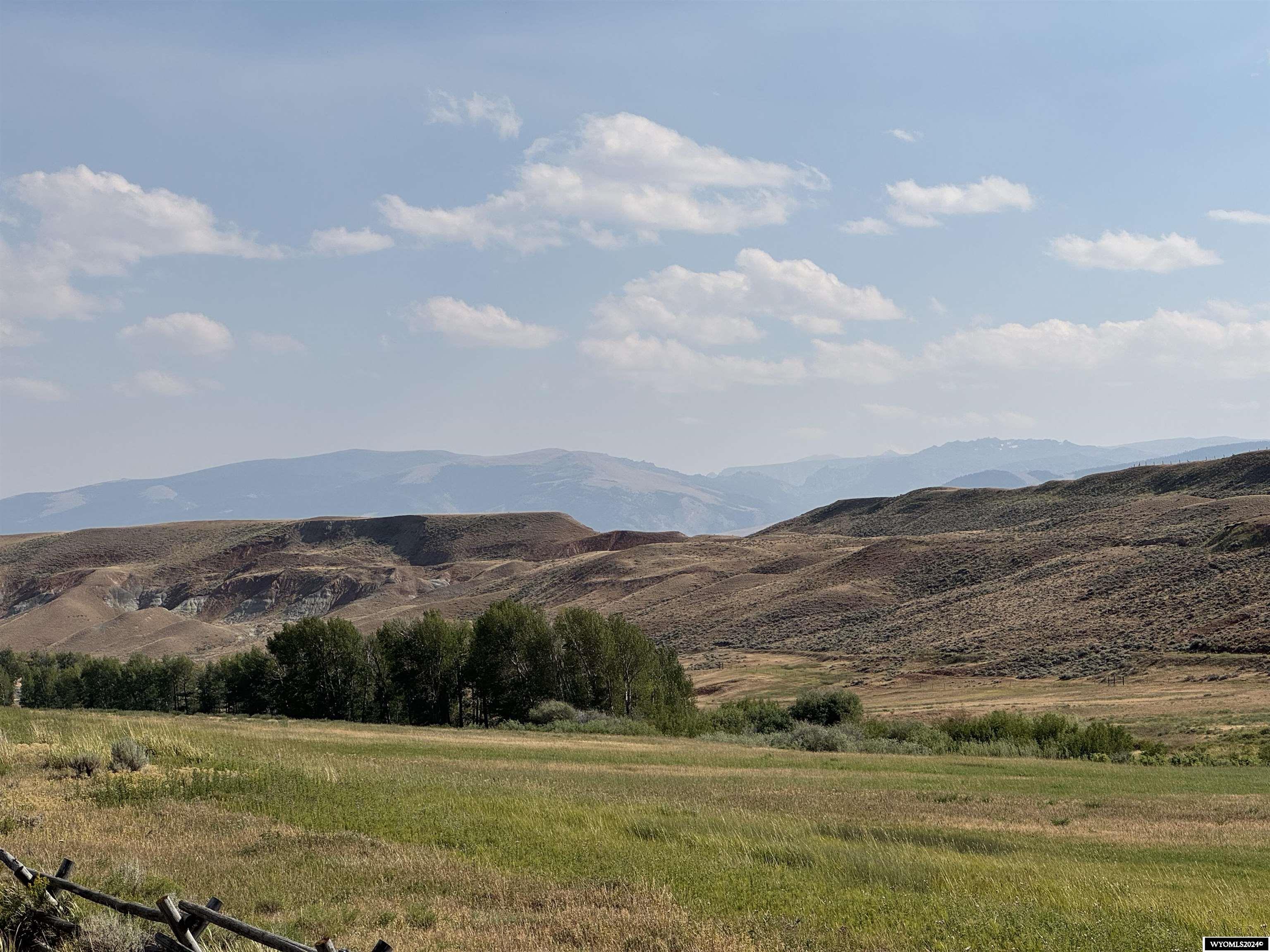 Currently crop and grazing lands this 80 acres, 5 miles north of Dubois has multiple use options.  This acreage has crop land, Little Horse Creek flowing through it, painted hillside mountain, mature trees, and borders BLM property.  This has no restrictive covenants so bring your imagination and build a dream ranch, develop much needed housing in the area, or have a retreat for recreation and hunting.  Served by a well maintained road this parcel is just a few miles from trail systems through public lands that have camping sites, lakes and streams for fishing and are known for having an abundance of wild game.  Panoramic views surround the entire property.  An hour and half from the Jackson Hole area, Yellowstone and Teton National parks, and the hot springs of Thermopolis.  The Dubois airport is only 10 minutes away.
