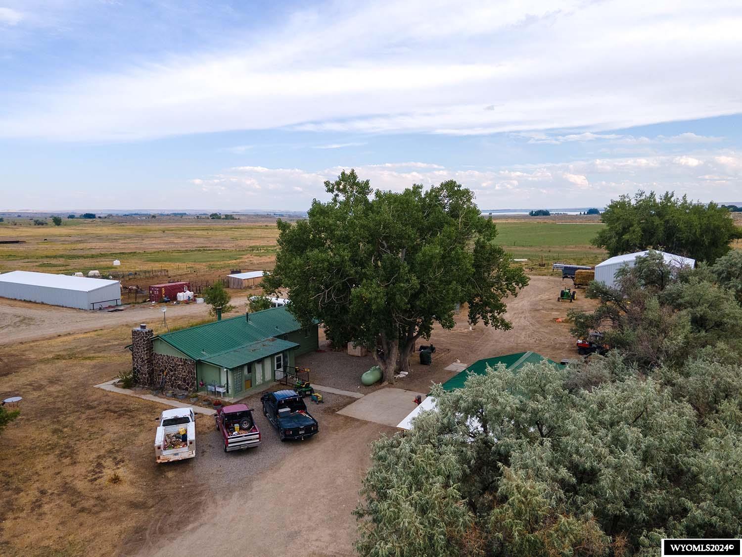 Nestled in the heart of Wyoming's picturesque Fremont County, this farm spans just over 80 acres and has Midvale irrigation rights. The property features a charming 2-bedroom house with the perfect blend of rustic charm and modern comfort, making it ideal as a farmhouse for the property. It has updates, too - like a brand-new permitted septic system!  The farm has a large hay barn and a spacious three-sided horse barn. A heated goat barn and a chicken coop add to the farm’s versatility. There is electricity to the sheds for convenience, and a two-car garage with an integrated workshop provides a space for all your projects.  You'll find mature trees on the property that provide shade and add to the tranquil setting. The land produces a reliable hay crop that can serve as an additional income source or feed for livestock. But one of the most striking features of this property is its breathtaking panoramic views of the Wind River Mountains, a constant reminder of the beauty of this area!  Located within the Wind River School District, this farm is ideal for seeking strong educational opportunities in a close-knit community.  This property offers a rare chance to own a farm in a prime location, whether you want to expand your agricultural ventures or simply enjoy a peaceful rural lifestyle. Note this property is in Pavillion, Wyoming. It is approximately 25 miles from downtown Riverton.  Don’t miss out on making this farm your own! Call Wind River Realty at 307-856-3999 to schedule a private showing today!