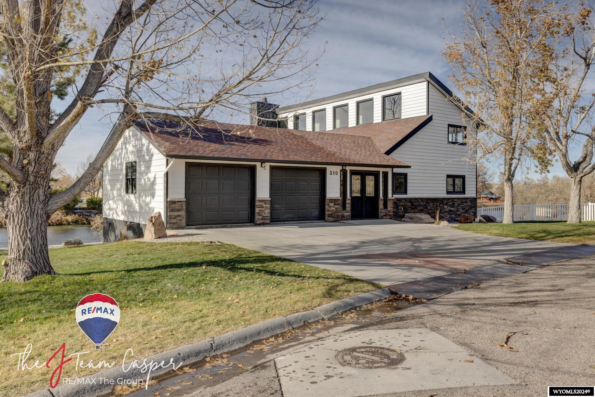 Welcome to this exceptional, fully remodeled contemporary riverfront home, where modern elegance meets nature's beauty. Nestled along the Platte River, this property offers breathtaking water and mountain views and an unmatched connection to the outdoors. Designed for luxurious comfort and seamless living, every detail of the home has been thoughtfully updated with high-end finishes, clean lines, and an open-concept layout.  Step inside to discover expansive windows that flood the living spaces with natural light and frame stunning views of the river. The chef’s kitchen features top-of-the-line appliances, sleek cabinetry, and a spacious island perfect for entertaining. The living room’s modern fireplace provides a warm focal point, while sliding glass doors offer easy access to the oversized wrap-around deck—a perfect spot for al fresco dining, relaxation, and soaking in the serene riverscape.  The main floor primary suite is a true retreat, complete with a spa-like bathroom, walk-in closet and en-suite laundry. Outside, the lush landscaping, river access, and shore side fire pit are perfect for fishing, or simply unwinding by the water.  This one-of-a-kind riverfront home combines contemporary style with the tranquility of waterfront living—ideal for those seeking a sophisticated escape with proximity to nature.