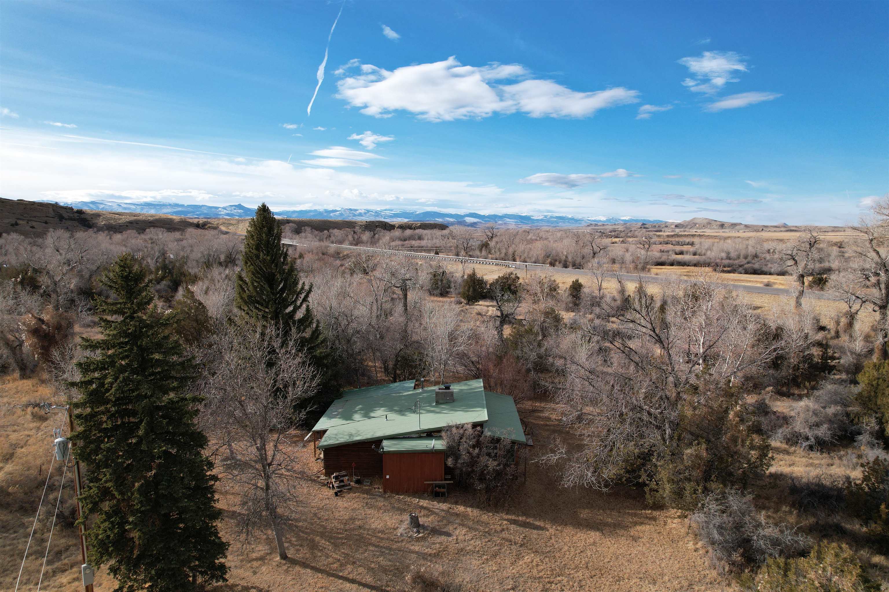 Exclusive Wind River Property – A Rare Opportunity Awaits! Discover nearly a mile of stunning Wind River frontage, offering you the unparalleled experience of owning both sides of this pristine waterway. This extraordinary property is a haven for outdoor enthusiasts, featuring: World-Class Hunting: Abundant big game, waterfowl, and upland birds. Exceptional Fly Fishing: Home to thriving populations of brown and rainbow trout. Natural Beauty: Towering mature trees, open spaces, and breathtaking river views. The property includes a cozy one-bedroom cabin that is move-in ready and a charming historic homestead full of potential for renovation. With direct highway access, this secluded retreat is as convenient as it is captivating. Whether you're seeking an outdoorsman's paradise, a serene getaway, or a canvas to create your dream estate, this property offers it all. Opportunities like this are rare – don’t miss your chance to own a slice of Wind River paradise! An additional 117 acres m/l with more homes and irrigation rights are available.