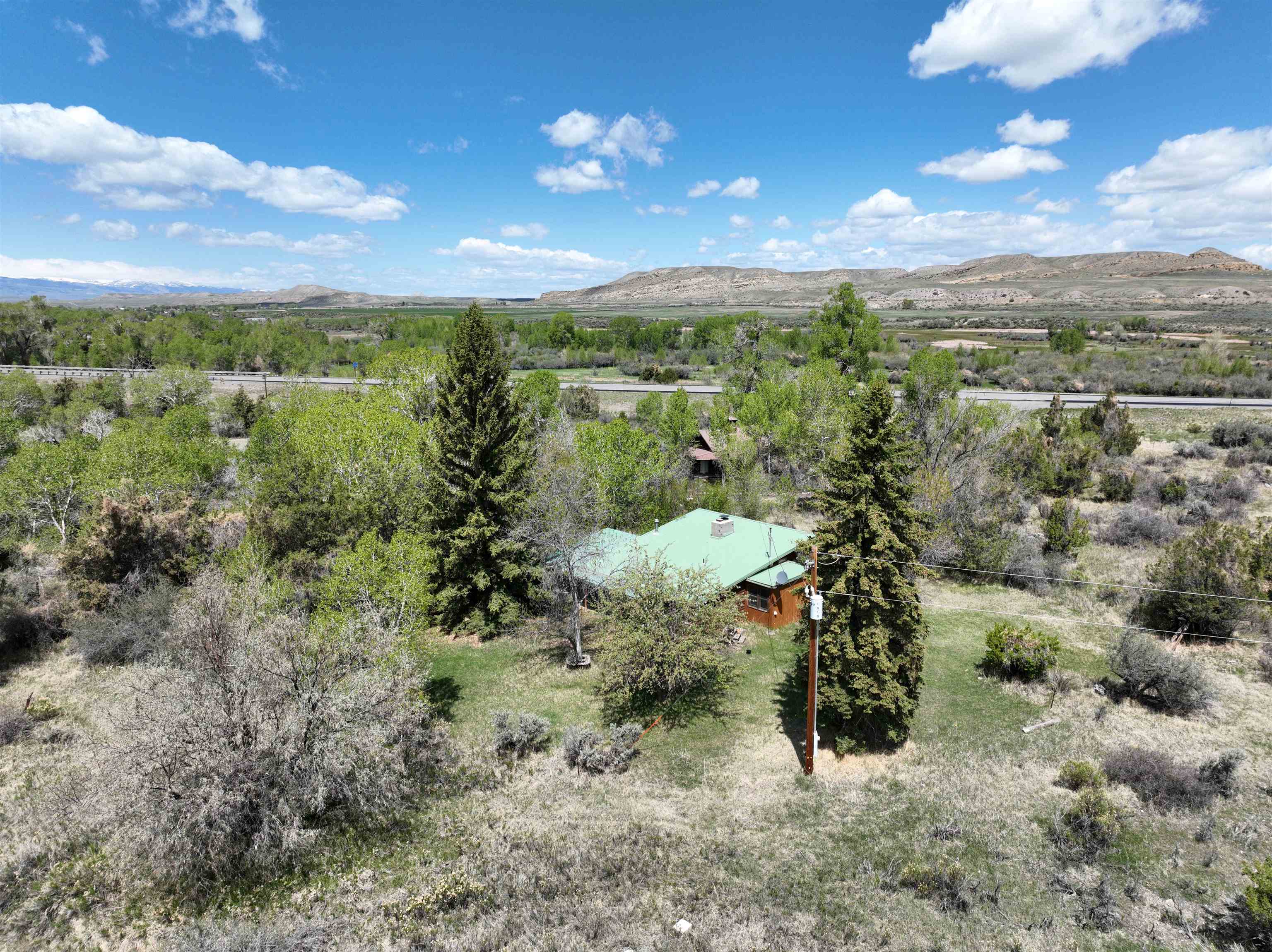 Exclusive Wind River Property – A Rare Opportunity Awaits! Discover nearly a mile of stunning Wind River frontage, offering you the unparalleled experience of owning both sides of this pristine waterway. This extraordinary property is a haven for outdoor enthusiasts, featuring: World-Class Hunting: Abundant big game, waterfowl, and upland birds. Exceptional Fly Fishing: Home to thriving populations of brown and rainbow trout. Natural Beauty: Towering mature trees, open spaces, and breathtaking river views. The property includes a cozy one-bedroom cabin that is move-in ready and a charming historic homestead full of potential for renovation. With direct highway access, this secluded retreat is as convenient as it is captivating. Whether you're seeking an outdoorsman's paradise, a serene getaway, or a canvas to create your dream estate, this property offers it all. Opportunities like this are rare – don’t miss your chance to own a slice of Wind River paradise! An additional 117 acres m/l with more homes and irrigation rights are available.