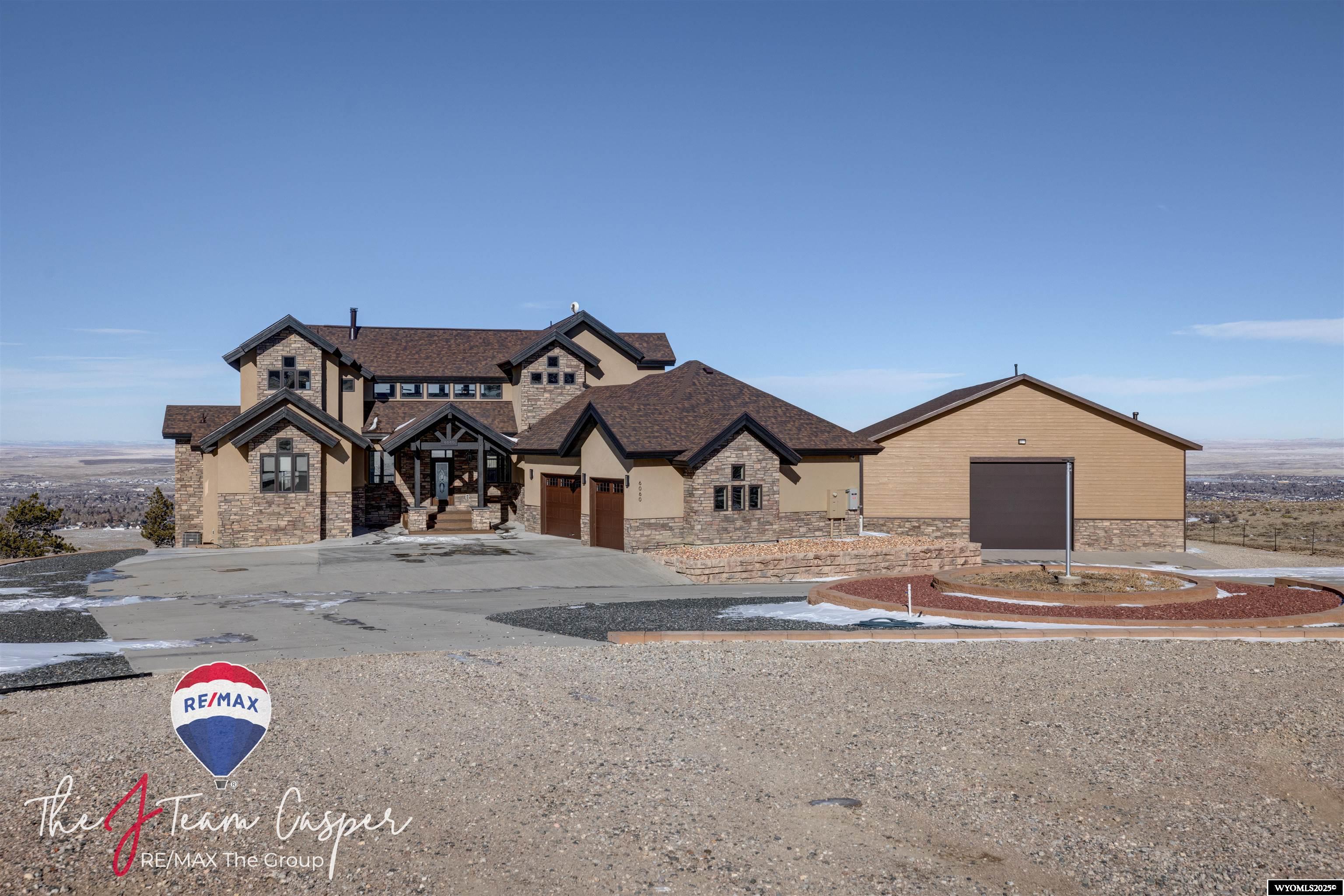 Discover this stunning two-story home nestled at the base of Casper Mountain, offering breathtaking views of both the city of Casper and the mountain itself. Thoughtfully designed, the home's strategic window placement ensures you can fully enjoy the surrounding scenery.  Recent updates have enhanced this property, including a new roof, fresh interior and exterior paint, updated flooring, an added bathroom in the attached garage, and a dedicated laundry space in the primary bedroom. The landscaping has been revitalized with a sprinkler system, new sod, rocks, and plants.  This home is perfect for entertaining, with an expansive deck and a cozy fireplace that provides the ideal spot to admire the city lights. Sitting on 3.29 acres, the property includes an attached three-car garage and a detached, heated 3,500-square-foot shop with a mezzanine and 16-foot drive-through doors.  This exceptional property combines beauty, functionality, and space, making it a perfect place to call home! Contact Jennifer Gladson 307-259-5074 or John Lichty 307-262-1648 for your private tour.