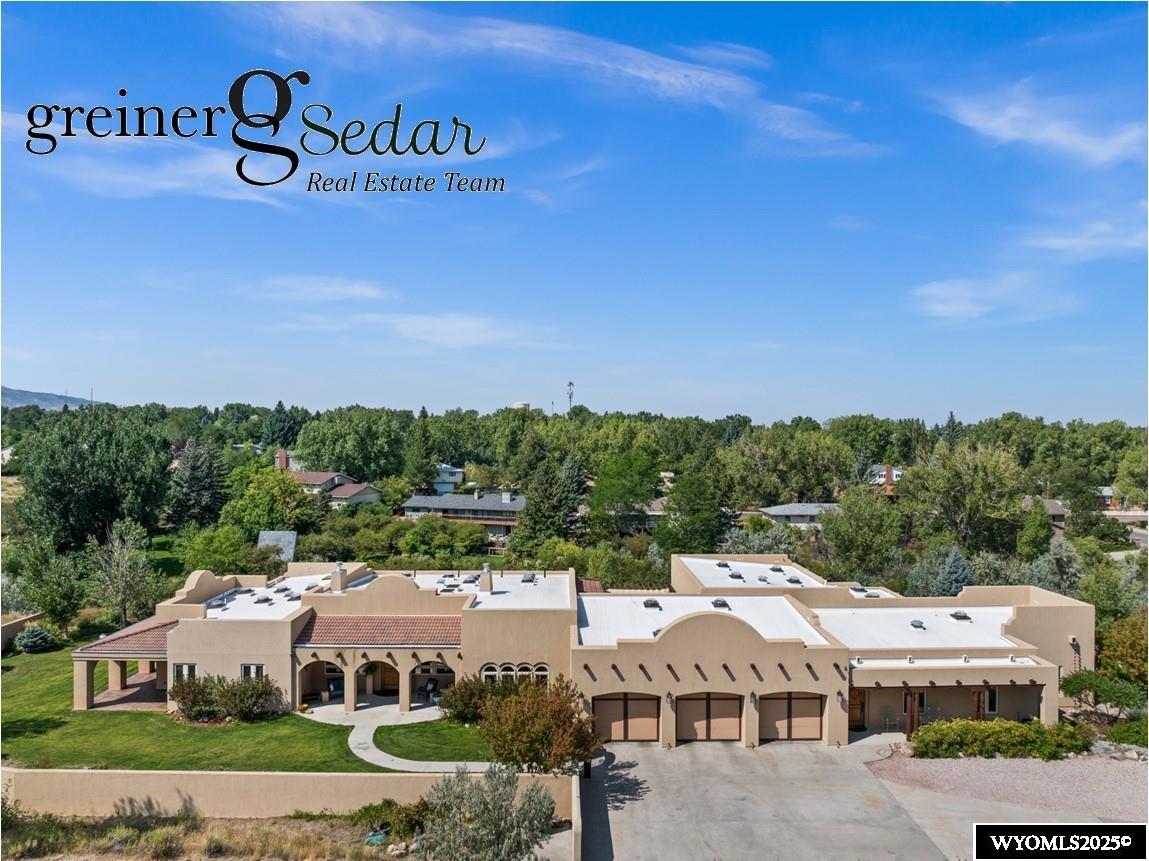 This Santa Fe Style Home has a distinctive architectural style all its own. Solid 9 ft Knotty Alder Doors and trim throughout. Ceilings accented with lodgepole beams. Programmable lighting and fireplaces in both the Living Areas and Formal Dining. Spacious but cozy rooms create an element of both comfort and charm. The 2.8 acre property is located along Garden Creek and has unobstructed Mountain Views. Exterior walls are insulated concrete forms (AAXX) 50R factor. Radiant floor heat throughout including the oversized 3 car garage. Hot water recycle system, Pella Windows, Central Vac System, Security System. Garage and Shop walls are built of Plywood.  A  970 sq ft Game Room and Additional Living quarters are separate from the main house. 1300 sq ft shop with full bath and additional finishing room. Two Primary suites with patio area. Exquisite Kitchen with center island, walk-in pantry, breakfast dining with full floor to ceiling windows accessible to a Romantic outdoor pergola patio area with a center water fountain and garden areas. This home is fully handicap accessible.  So many wonderful appointments throughout that you will thoroughly enjoy touring this very special property.