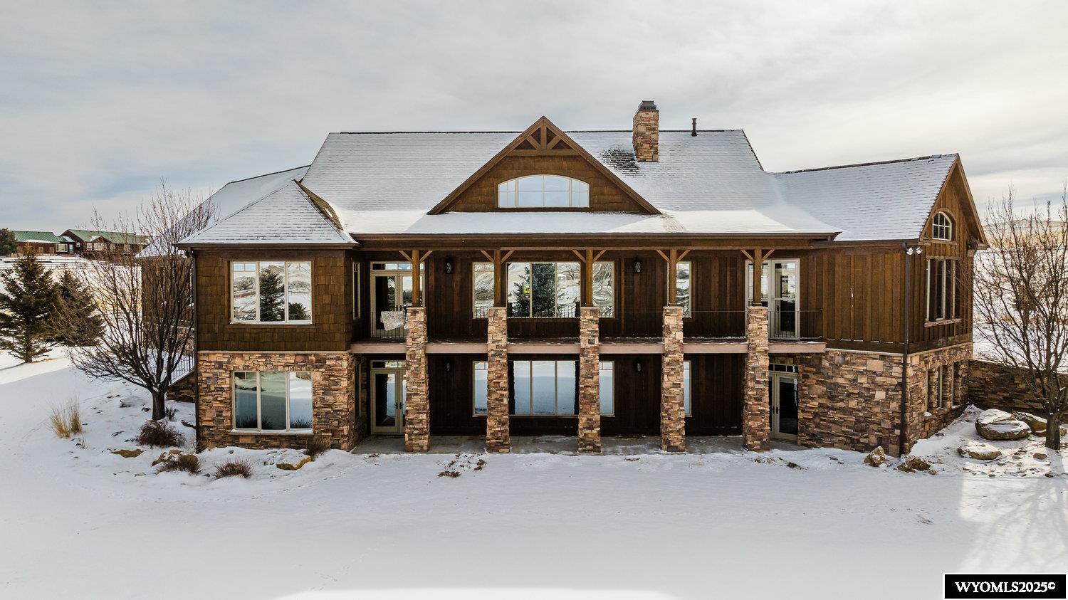 Welcome to Funny Bird Lane, located between the Johnson Creek and Sand Creek drainages at the foothills of the Bighorn Mountains.  This is more than just a home; it is a lifestyle surrounded by natural beauty.  Custom designed by Diamond Point Construction, this exquisite 4BR/4.5 BA masterpiece radiates warmth, natural light and thoughtful design. Beyond the front entrance awaits a welcoming stone fireplace warming a large living area, opening into an elegant chef's kitchen and formal dining, all with magnificent views.  The main level also features a large primary suite, second bedroom, 3/4 bath, private office, laundry area with sink and cabinetry for storage.  The loft area would be ideal for a reading nook or art studio.  The lower level, walkout basement offers a theater room, second kitchen and dining area perfect for memorable gatherings. Plus, two large bedroom suites with spacious closets, and an exercise room.  The home is heated with radiant floor heat for ultimate comfort.  A large balcony provides immediate access to the fresh mountain air and breathtaking views.  From the lower patio you will enjoy beautiful landscaping with a water feature, complimented by the natural beauty of the property.   Additional improvements include over 2,100 s.f. of shop space, plus a 600 s.f. loft, office with 3/4 bath and additional storage room.  Plenty of room for boat storage, all of your outdoor toys and barn needs.  Both home and shop have concrete wall construction.  The equestrian enthusiast will appreciate the post and rail perimeter fencing with ample pasture for two horses.  Outside the shop/barn is a hitching rail and plenty of space to customize your dream tack and feed room.  This 5 acre estate offers privacy and a harmonious blend of luxury and scenes of Wyoming's beauty.