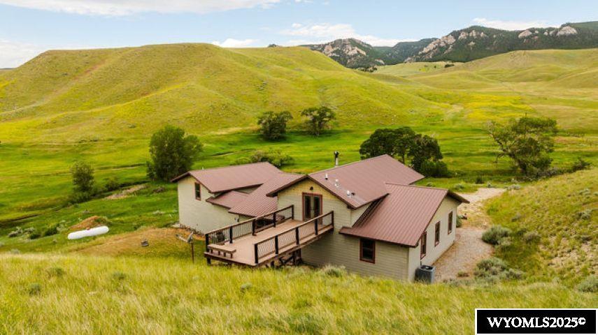 Follow the small private road nearly to the end of the secluded valley and experience a rare and captivating site, an imaginative custom home nestled against a rushing trout stream and guarded by the lofty, jagged foothills of the Bighorns. Lurking in the 1/3 mile of Little Crazy Woman Creek that runs through the property, brown trout as large as 15” hide. The craggy spires of Sisters Hill, a local landmark, shelter the property from the north.This is one of Johnson County’s most rare and unique properties.Being there is the only was to appreciate the solitude and grandeur of this property, so please come and check it out. Located in a small valley with only a limited number of other homes, this location is intimate and could be considered remote....perfect for a private get-away, but also suitable and accessible for year round living. Excellent pasture for horses or livestock projects, the property is fully fenced and has a barn/shop that can be utilized for work/storage space or livestock barn.  Don't want animals? 40 acres allows for privacy and protection of views. Property is surrounded by larger ranch interests and property seldom changes hands in this area.   Interior finishes include but are not limited to: Hickory cabinets and floors, pressed tin ceiling, Brazilian soapstone countertops, exposed beams, yellow limestone baseboards and tiles, Tulikivi soapstone wood stove, Chinese slate water wall, library, loft, T and G hand finished Canadian cedar walls and ceiling, hand carved crown molding, west facing wall of windows, 18 1/2 foot ceilings (living room), hand painted decorative tiles and full, Anderson windows and doors, and easily finished basement. A "land line" phone line is available as well as 7 MB internet through Century Link, however, cell service is very limited.    Exterior features include: Balcony, large deck (12x28), 30’x40’ Cleary pole barn, large stained concrete front patio (20’x45’), sturdy steel beam bridge over the creek is designed to accommodate the heaviest loads. Water for this home is obtained from a permitted right off Crazy Woman Creek supplemented with a purification system. (See attached Special Property Features Detail)    For a showing with all the details, please call Karen Buffington, Associate Broker, Coldwell Banker The Legacy Group, 307-620-5435.
