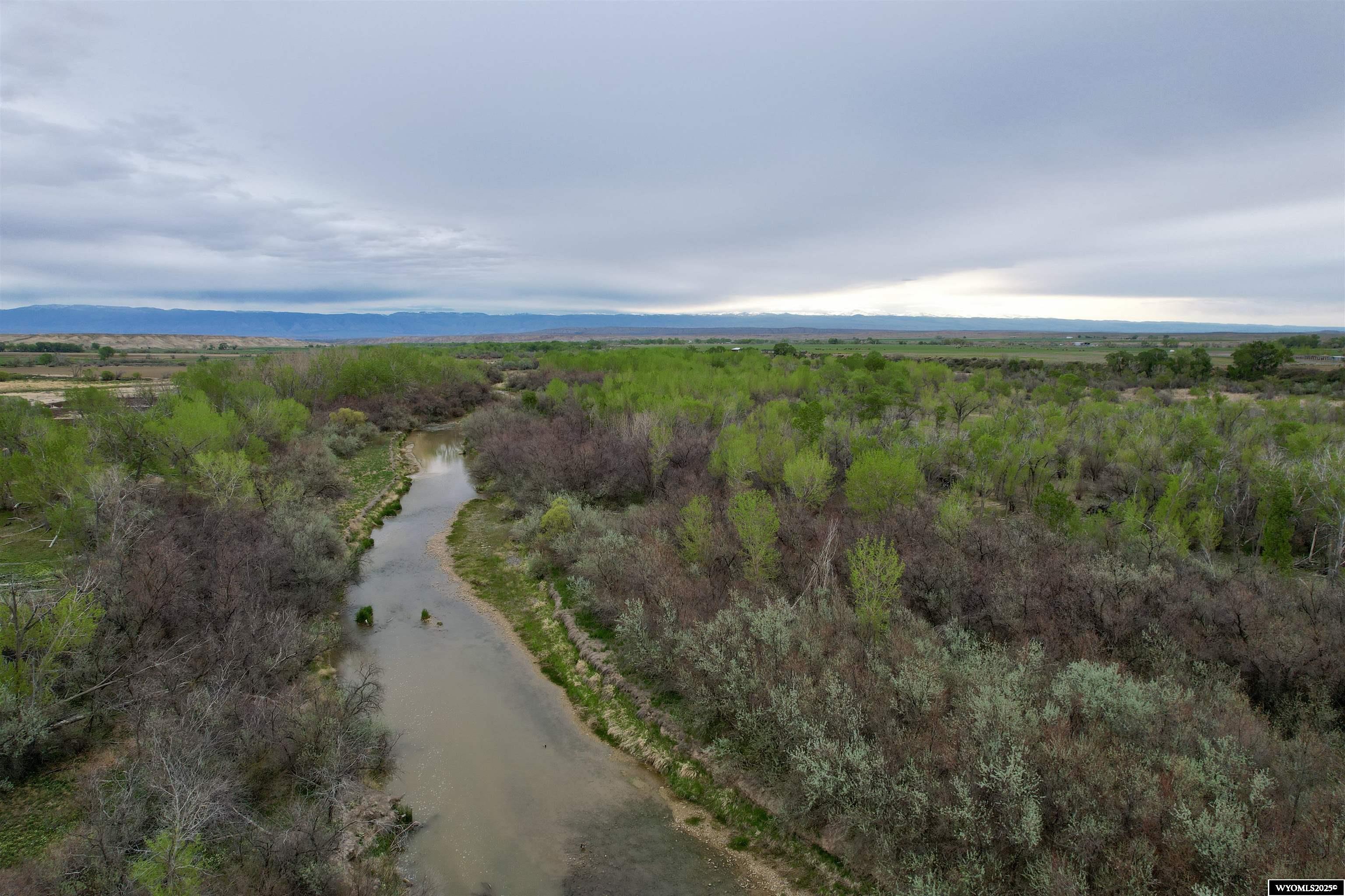 Take a look at this farmstead, with home, shop, and corrals on approximately 63 acres. There is a small irrigated pasture and sub irrigated river bottom. Amazing wildlife and hunting opportunities are a bonus on this property, with elk migrating through most fall and winter seasons. Mule deer, whitetail deer, antelope, and pheasant are abundant. The current owner has harvested elk on the property. Mountain views, natural springs, and river, all on the property, create a beautiful living environment. This property boasts a heated and insulated 40x60 shop, corrals, and loafing shed, all currently in use and in working order. For those longing to live on the land, this is an amazing opportunity! Taxes are TBD, as this is being split from a larger parcel. $3,500 is an estimate of what taxes may be. A survey is being done and a legal description is forthcoming.