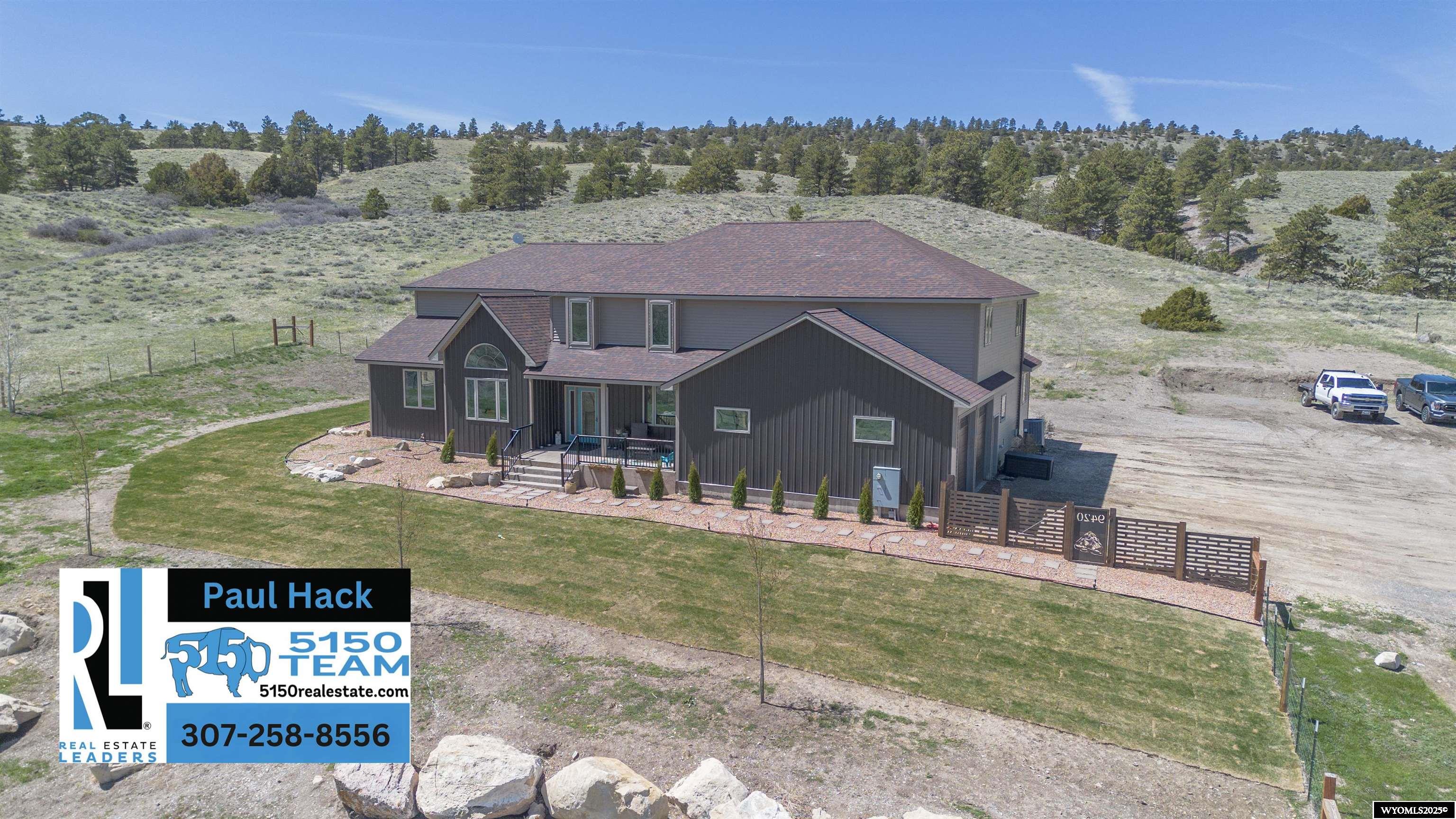 Dreaming of a Home Where the Buffalo Roam? Look No Further!  Escape to the tranquility of rural Wyoming at 9420 Hwy 220, just a short drive from Casper’s city limits. Set on an expansive 26.3-acre property, this stunning 2-story residence offers the perfect blend of peaceful country living and convenient access to modern amenities.  Built in 2013, the home boasts 4 bedrooms, 4 bathrooms, and an impressive 4,884 sq. ft. of thoughtfully designed living space. Step inside to discover vaulted ceilings in the great room, two inviting dining rooms, four separate family rooms with private space for everyone, a main floor primary retreat complete with five piece bathroom and his and her closets and a kitchen to make the most experienced chef jealous.The spacious, light-filled interiors are perfect for both everyday living and grand entertaining.  Take in breathtaking panoramic views from the rooftop deck, offering an unmatched vantage point of Wyoming’s natural beauty. For those with hobbies or livestock, the property features two barns—perfect for all your 4H animals—and a cleared area ready for the construction of a large shop, giving you endless possibilities.  The attached oversized two-car garage ensures convenience, while the surrounding open space offers endless opportunities for recreation and relaxation. This rare property is a dream come true for those seeking a rural lifestyle without sacrificing proximity to Casper’s amenities.  Don’t miss your chance to own this incredible property. Schedule your private tour with 5150 Real Estate Team 307-264-5150  today!