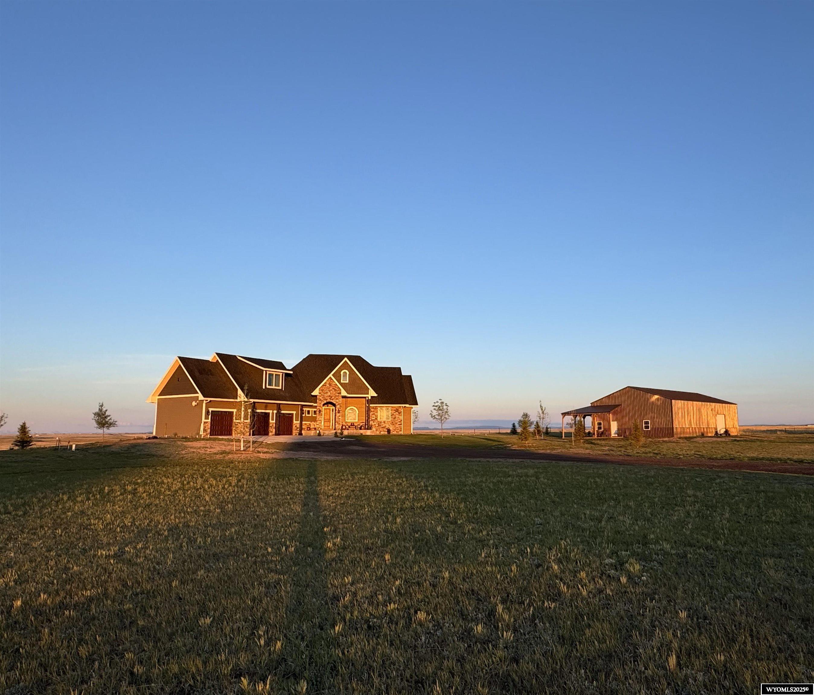 Stunning custom-built rural home with breathtaking views. This one-of-a-kind property boasts custom stained trim and doors, granite throughout, walk-in pantry, Viking appliances, on demand hot water heater, two furnaces, custom tile and stone, three fireplaces, vaulted ceilings, finished bonus room with walk-in closet, main floor laundry and a fully finished basement with a stunning wet bar, bourbon room, game room, finished storage area and two bedrooms with egress windows. The 40'X72' shop has 16' ceilings to house any size RV and 500+ sf heated, finished office/workout room. Call for your private showing today!