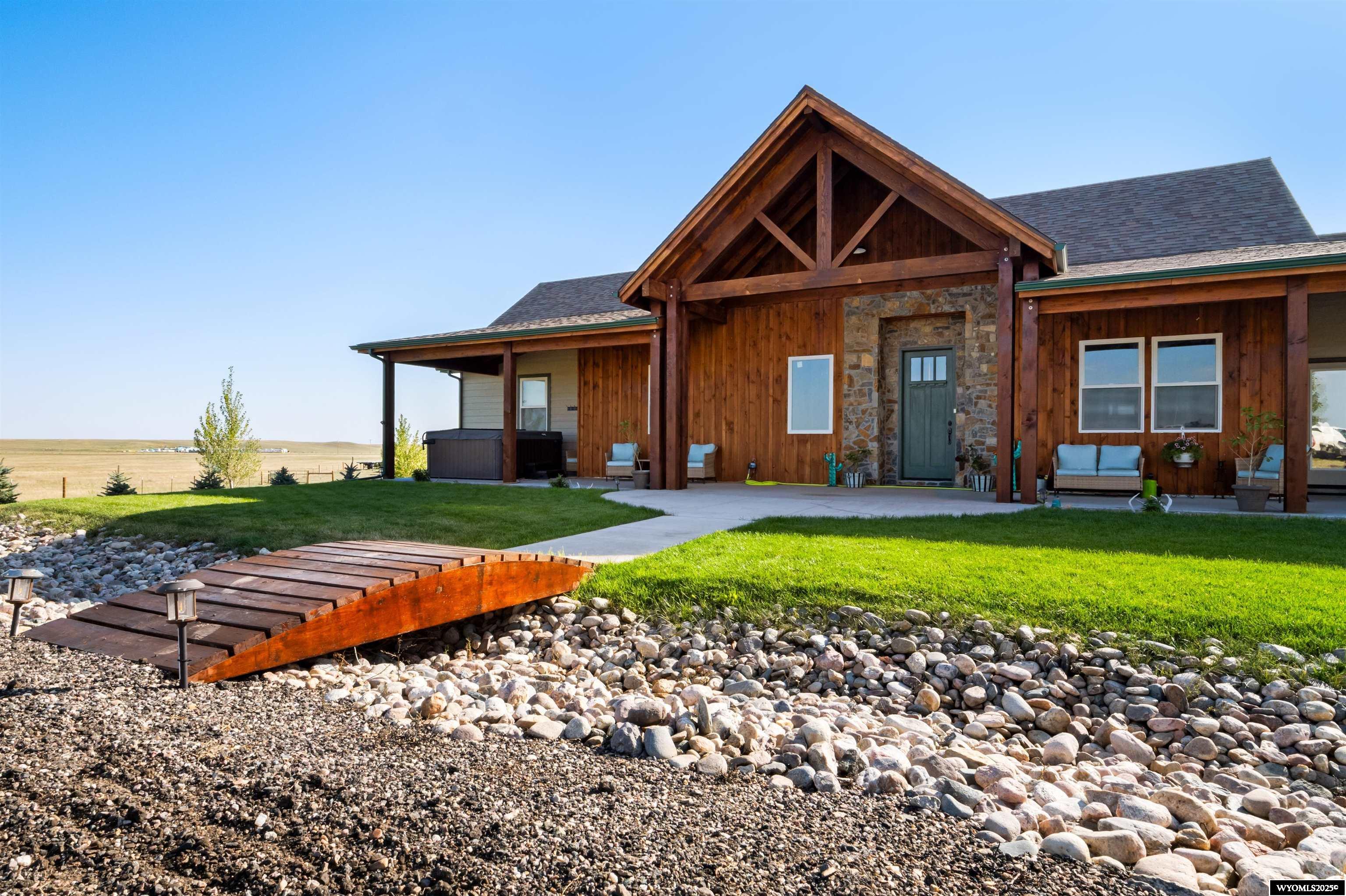 Embrace the rural lifestyle at its finest! Nestled just 12 minutes from town, this custom-built residence stands as one of Laramie County’s premier equestrian properties. Upon arrival, you are greeted by a harmonious blend of stone and a meticulously manicured lawn, leading you to a meticulously crafted custom timbered porch. Upon entering your home, you are enveloped by an open floor plan, custom hickory floors, genuine wood trimmings, a cathedral ceiling, and high-efficiency fireplaces. This spacious design exudes warmth and comfort, creating an inviting atmosphere for you and your guests. Your horses w