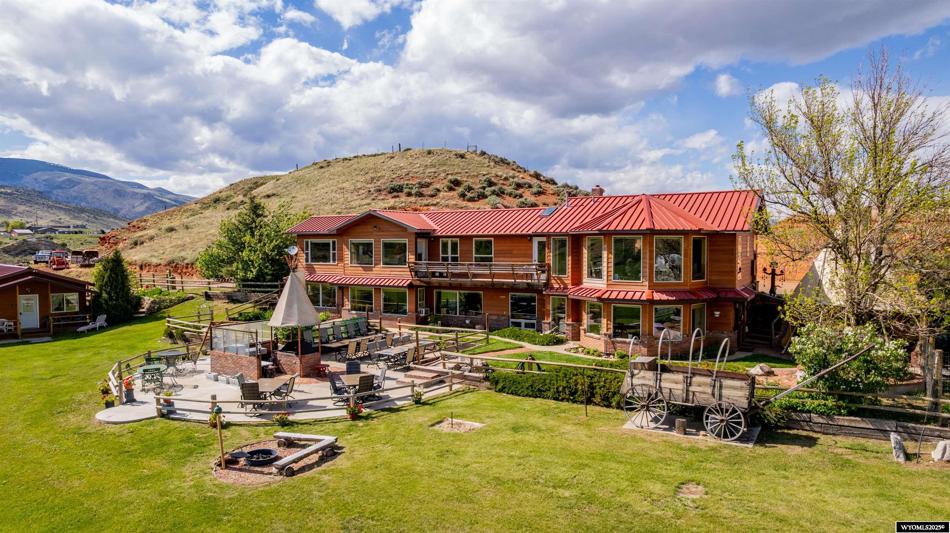 K3 Ranch – A Western Retreat in the Heart of Cody, Wyoming Set on 33 acres of what was once a working sheep and cattle ranch, this one-of-a-kind property has evolved into a beloved destination in the scenic heart of Cody, Wyoming. Just minutes from downtown and offering easy access to Yellowstone National Park and the stunning Shoshone National Forest, K3 Ranch is perfectly positioned for adventure, relaxation, and authentic western hospitality. The centerpiece of the property is a 3,660 sq ft main home featuring 3 spacious bedrooms and 4 bathrooms, each uniquely western-themed with custom design elements that give every room its own character. A generous common area on the main floor captures breathtaking views of the South Fork Valley, creating the perfect gathering space. Downstairs, a walkout basement is equipped with a commercial-certified kitchen and a large dining area that flows seamlessly onto outdoor patios with grills and seating—ideal for group meals and entertaining under wide Wyoming skies. K3 Ranch offers multiple lodging options beyond the main home, including: 2 guesthouses, each with kitchenettes and private bathrooms, 2 custom sheep wagons, complete with electricity, heating/cooling, water, and access to nearby bathhouses, and a charming tent house. Whether you're envisioning a private retreat, a bed and breakfast, or a guest ranch business, K3 Ranch offers limitless potential. First Right of Refusal in deed.