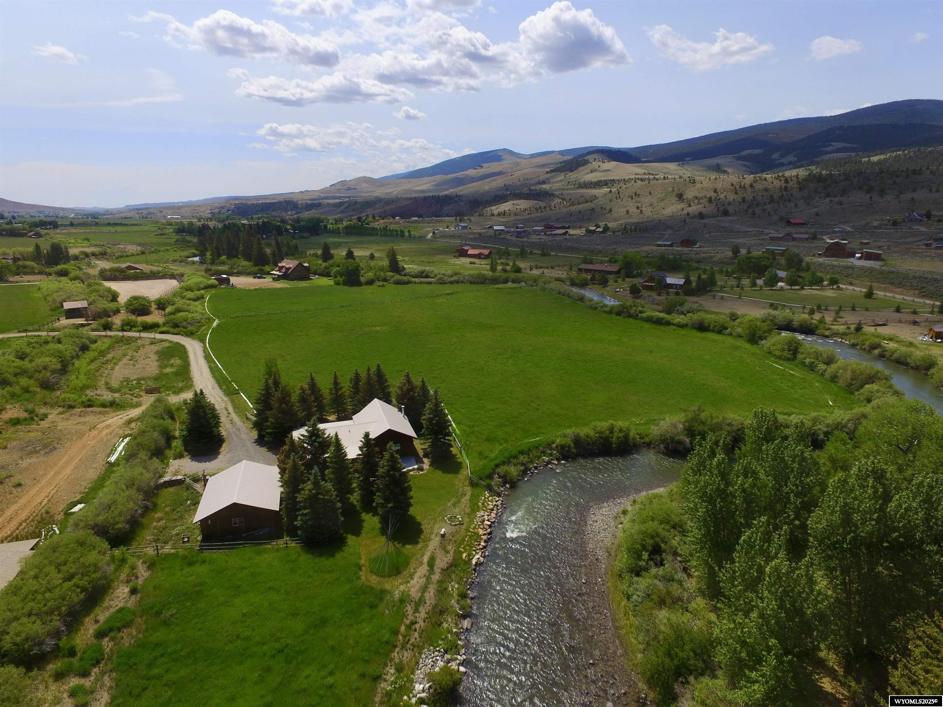 35 acre parcel, irrigated hay ground with a beautiful home and horse/ tack shed. The 1690 sq. ft. 3 bed 2 bath house has amenities such as: Wood floors, vaulted ceiling, granite counter tops, tile and log accents, Glassed in porch, deck, and a river side patio. The partial basement is easy to access and excellent storage.The detached 1 car garage/shop is finished and makes a great workshop. The property is irrigated and produces quality hay and horse pasture. 1300 ft. of the Wind River river borders this property, a Fantastic fishing property!