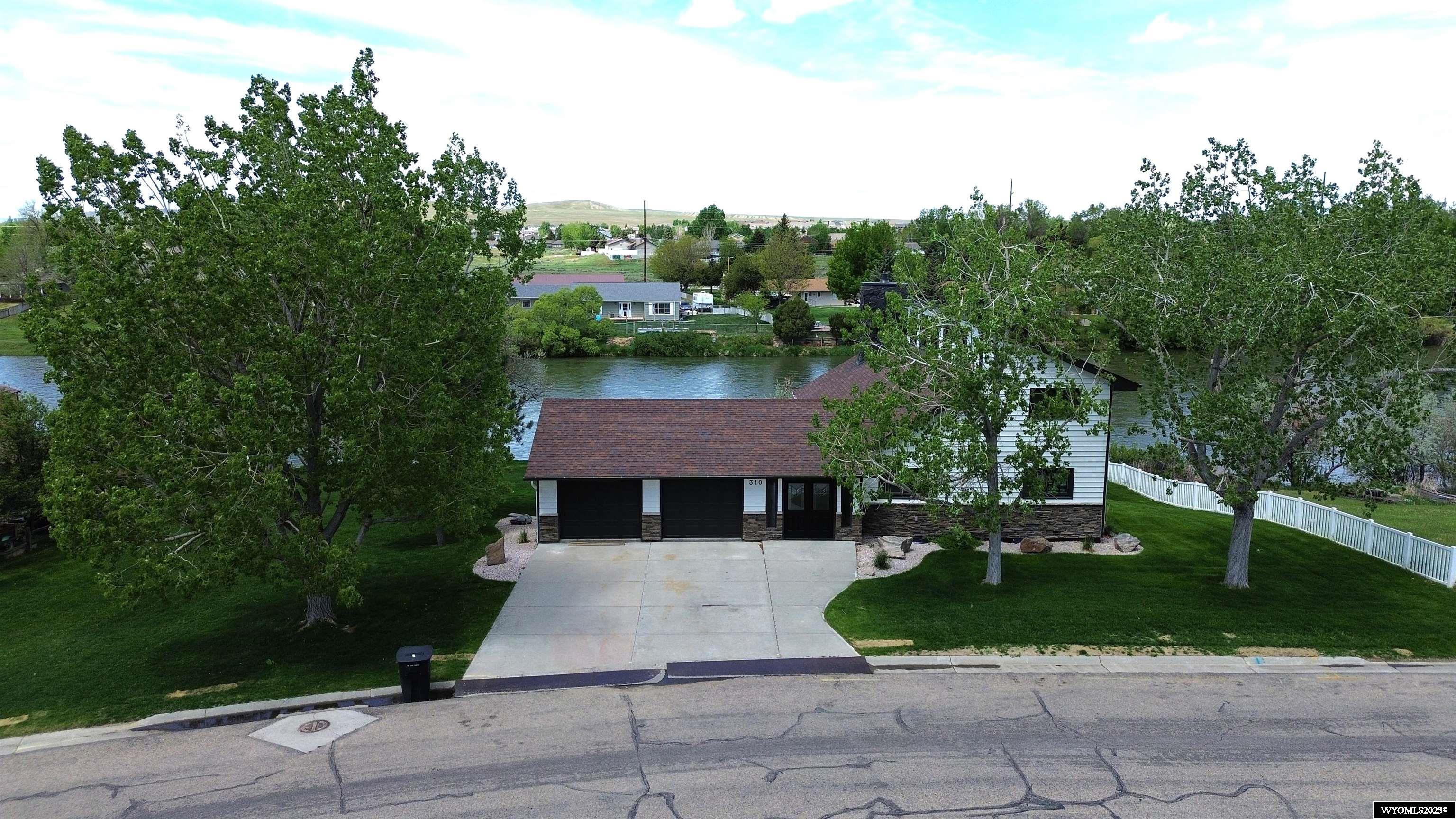 Remodeled Riverfront Home with Incredible Views on the North Platte River! Welcome to your dream home on the North Platte River a fully remodeled 1 and a half story retreat where stylish updates meet the peace and beauty of nature. From the moment you arrive, you’ll be wowed by the breathtaking river and mountain views and the unbeatable access to the outdoors. This home has been completely updated with high quality finishes and a fresh, open layout that’s as functional as it is inviting. Large windows fill the space with natural light and perfectly frame the river just outside your door. The chef’s kitchen is ready for entertaining with top tier appliances, sleek cabinets, and a spacious island where everyone can gather. The living room features an electric fireplace and sliding glass doors that lead to an oversized wrap around deck ideal for outdoor dining, relaxing, or simply soaking in the view. The main floor primary suite is incredibly spacious, offering a peaceful retreat at the end of the day. In the primary bathroom, you'll love the large tiled shower with glass enclosure and a soaker tub perfect for unwinding in style. A generous walk-in closet and private laundry area add both comfort and convenience. Step outside to enjoy beautiful landscaping, direct river access, and a shoreside fire pit perfect for relaxing, entertaining, or cozy evenings under the stars. From your backyard, you’re just steps to the river whether you're floating the North Platte or enjoying world-class fishing, it’s all right at your fingertips. This one-of-a-kind home blends timeless design with comfortable, updated living. Whether you're searching for your forever home or a weekend escape, this riverfront property is a rare find that truly has it all.