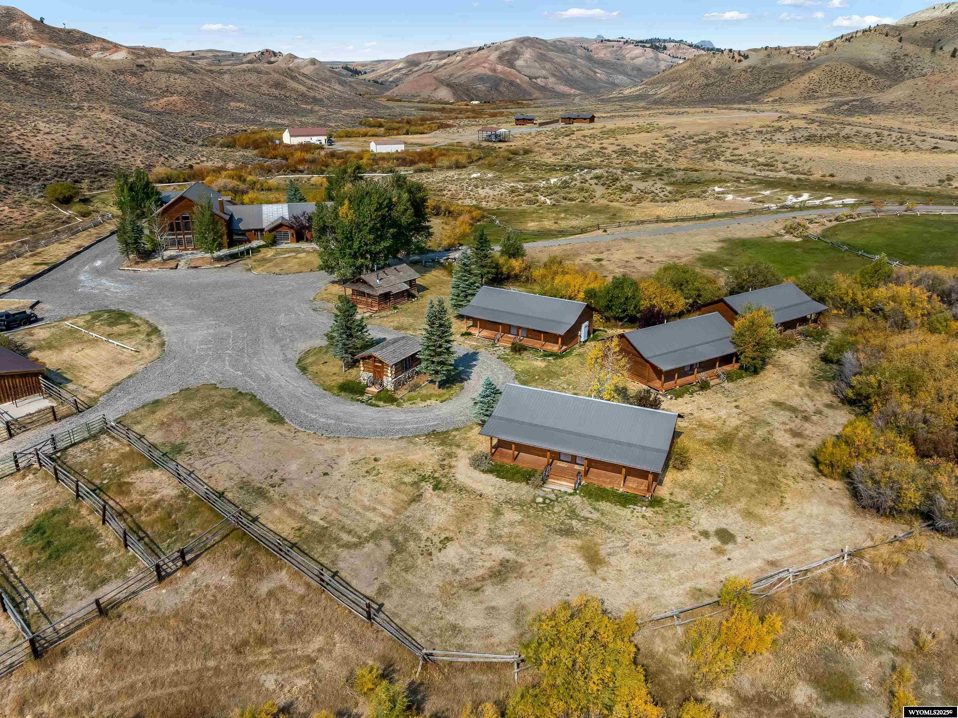 Waterfront Acreage >  Along the serene Horse Creek, this ranch offers natural beauty and endless opportunities for recreation and relaxation. With a total of 8 buildings and mountain views, this property borders an additional 35-acre and 80-acre lots, both of which are available. The windows throughout the lodge show off the mountains and the river valley, which are best appreciated at the ever-changing sunrise and sunset. The living areas are flooded with natural light, which creates a feeling of warmth all day long.    Only a 10-minute drive to downtown Dubois and to the North, you’ll find millions of acres of public land to explore forests, rivers, lakes, and mountains. Perfect for hiking, horseback riding, or any outdoor adventures. For grander excursions, Grand Teton National Park and Yellowstone National Park are approximately an hour away.  The Lodge: 7,700+ Square Feet of Rustic Elegance   This magnificent lodge is a blend of grandeur and Western charm. Key features include:  The Great Room: Vaulted ceilings, a floor-to-ceiling fieldstone fireplace, custom windows and sliding doors, wooden floors, chandeliers, and an open staircase. Beyond the grand entry is a cozy multi-use room that can be used for a private dining experience, a meeting room, or be turned into an additional bedroom.    Upper Level: The staircase leads to an intimate social area with a wet bar, fireplace, and half bathroom, plus a conference room with its own fireplace, storage areas, and outside access.   Commercial Kitchen: Fully equipped with a large exhaust hood, stainless steel sinks, a large pantry, and ample prep space.    Potential for Events: The lodge’s large deck provides a picturesque setting for weddings, family reunions, or other special events.    The laundry space is conveniently located at the back entrance for guests or staff. Across the hall from the laundry is a mud room with storage, cabinets, dishwasher, and a half bath.   The living quarters in the lodge feature:  - A vaulted living room with a fireplace. - A dining area leads to a large wooden deck with railings and mountain and river valley views. - A private kitchen - Upper-level bonus room. - Three bedrooms with ensuite bathrooms, one of which stands out with a fireplace, sliding patio doors, and breathtaking sunrise views over the river valley.  - A guest bathroom. - A business center with cabinets, counter space, and outside access can be turned into an additional bedroom.  The Office or Conference Center: 1,400 Square Feet of Versatility   This building features custom cabinets and workspaces with:  - Two rooms serve as private offices and can be converted into bedrooms.  - A finished storage area leads to a corner room with large windows and a fireplace, used for for private conferences.  With the layout, this structure could be utilized as a two- or three-bedroom home.  Guest Housing: Four Duplexes for Comfortable Accommodations  Built in the late 1990s and used sparingly, these four duplexes each include a front porch, one large bedroom, and another bedroom with a private entrance.    Built on concrete blocks and three-plus feet deep crawl spaces, where electric heat and water heaters.  Stables, Outdoor Pens, Arena  - Three indoor stalls with feeders, individual doors, and side wall skylight. - Seven gated pens, two large corrals, six stock tanks, and a working chute for livestock grooming and care.  This area is designed with functionality and comfort, perfect for horse or livestock operations.  Experience the Absaroka Mountains   The Absaroka Mountain Range surrounds the property, offering stunning views and endless opportunities for outdoor adventure. Whether you’re looking for a private retreat, event center, or working ranch, Horse Creek Ranch delivers an exceptional experience.