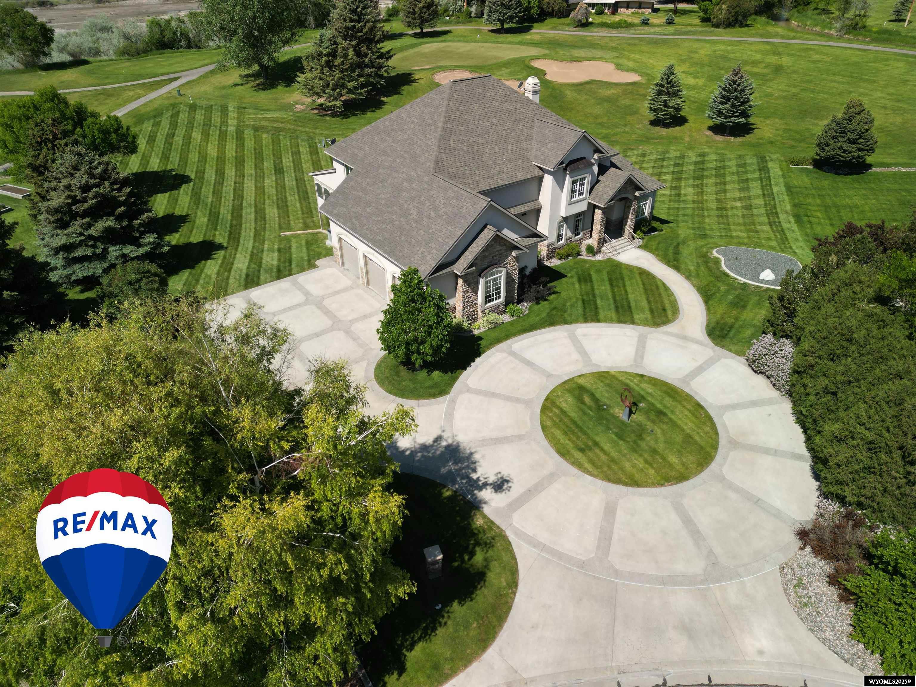 This is your chance to own perhaps the nicest custom home in all of Riverton! Built in 2003 by Dinwoody Construction this home will exceed all of your expectations in a home and any other home you view will feel inferior to 4251 Valley Green. The minute you come onto this beautifully landscaped property you will be amazed at the quality of construction starting with the exposed aggregate edged circle driveway ringing a custom sculpture with automatic night time lighting. Stepping onto the real stone front step, you will be amazed by the over 10' vault and in winter you will love that this front porch is heated for easy snow removal. As you first enter your eyes will be drawn to the over 20' arched vaulted ceiling with indirect lighting and built in surround speakers. This great room truly is the heart of the home with an amazing wall of glass that not only opens onto a Trex deck but also over looks the Riverton Country club behind. The glass wall features a oval glass arch with two quarter-circle glass panes on side to allow an abundance of natural light. Directly adjacent to the great room is the spacious Kitchen/Dining room. The Hardwood floors throughout are real Birch hardwood and these floors have been lovingly maintained. The fully custom kitchen features solid cherry wood cabinets from Newman Wood System's out of UT. This space features a very large center island, wrapped in seamless Corian counter tops with flush mount sinks and stainless steel appliances. The Cabinets feature pull outs and custom drawer dividers. Truly a chef's dream kitchen! The walk in pantry right next to the kitchen has multiple storage spaces, a roll up door to slide groceries from the garage directly into this space, and a house wide speaker system has it's data center in this room. All of the main entertaining spaces and outdoor spaces have speakers and individual volume controls. The Office features double cherry wood desks, Over and under cabinet lighting and a dual sided fireplace that opens onto the screen in 3 season deck. This space can be used 9 months a year thanks to the fireplace and the fans. Also on the main floor is a 28x40 floor heated/finished 3 car garage. All garage doors are extra tall and wide so vehicles of any size can fit. This space also has a wash sink and a 30A plug for electric vehicle charging. Also on the main is 2 Very large bedrooms with a very large primary bathroom between them. This wing of house was set up for "his" and "hers" sleeping arrangements with a shared bathroom in between. This bathroom has a seamless Corian shower and heated floors throughout. Downstairs is made for entertaining and features not only a insulated theatre room, but also a work out room, build in poker table, a pool table and 3 sided fireplace. There is also a second kitchen made for entertaining, but features a full suite of appliances also. In this lower level is a 4th garage that is also heated and has water and another 30A plug. This would make an ideal workshop, or potential cart storage space. The main floors and lower level are both heated with hydronic in floor heat and every level has it's own central air thermostat and air conditioner for easy temperature regulation. The high gas bill for this home is only $295 which is a fraction of the cost to heat a similar sized house with forced air gas. Outside you will love being the most private lots in the Country club and certainly some of the nicest planters thanks to the landscaper's Sweetwater Gardens. This lawn is watered with automatic underground sprinkler system fed of a private 100' deep well. There is also 3 tiers of Trex Decks so entertaining at this house would be a breeze. It goes without saying but you couldn't build this house for anywhere near the asking price. Don't wait and Call Skye Coleman-Weisz today at 307-851-0021 for a private showing or any questions!