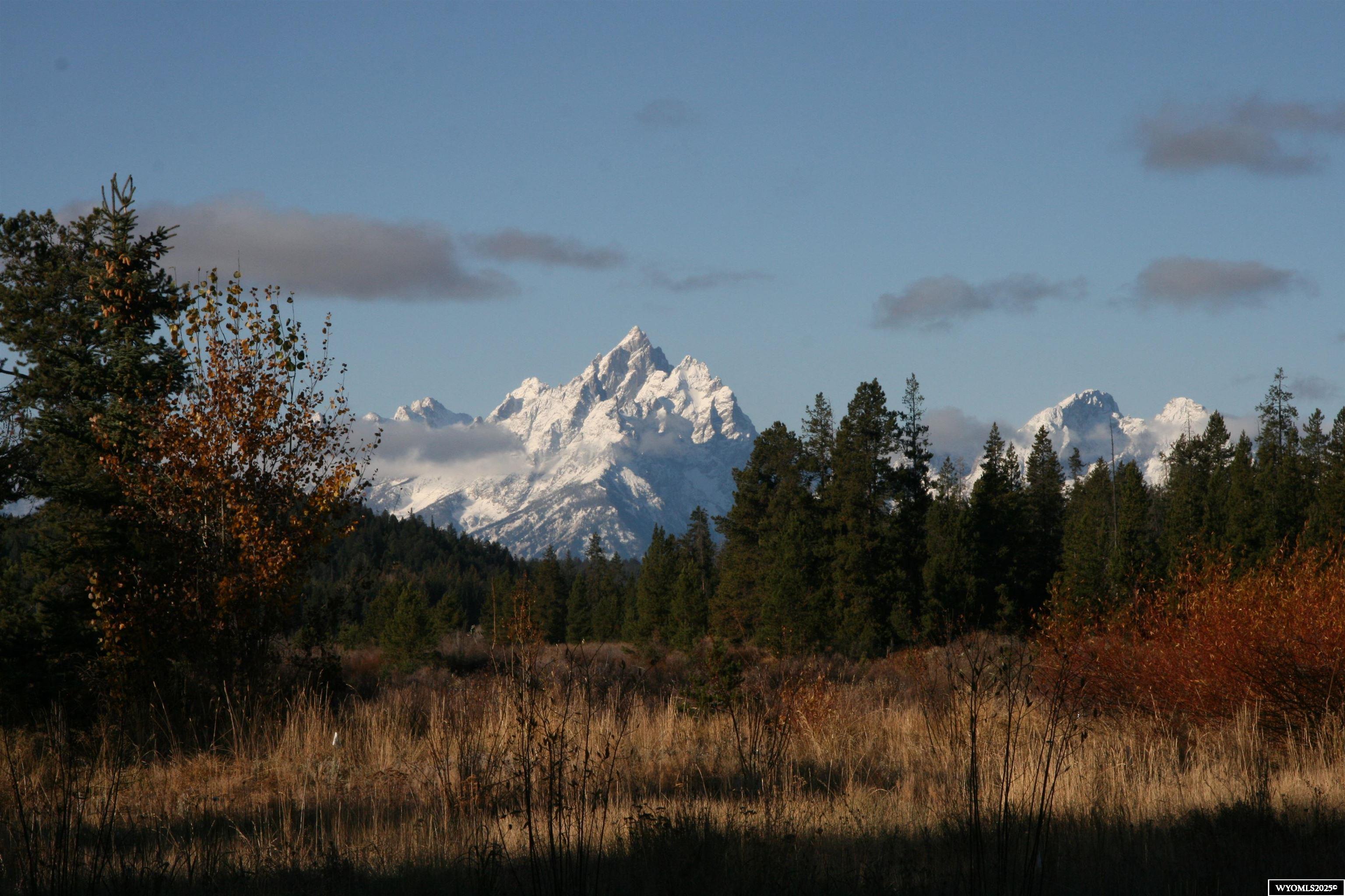 The View of the Grand Teton is your morning eye opener out the front window. A family home situated on 3 acres with a pond, large Boat house, completely sprinklered large lawn, with many mature trees. A unique private property inside the boundaries of the Teton National Park, and the Bridger Teton National Forest.