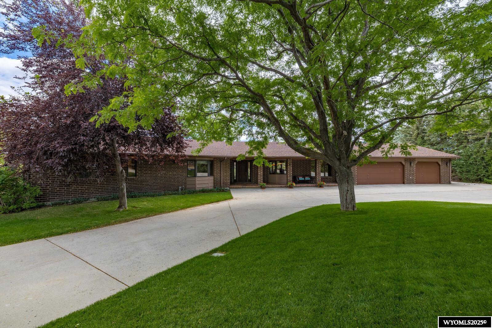 Fist day on market and MLS is 7/16/25. Amazing opportunity to acquire this custom ranch style home adjacent to the Casper Country Club from the original owners. 1.7 acres with dozens of mature trees, path to the golf course, rear patios and front porch. This magnificent home was built by Skip Cunningham and features a soaring great room with golf course and mountain views, built in bar area, book shelves, crown molding, fantastic sandstone fireplace, hardwood floors and multiple entertaining areas. The open kitchen, dining and breakfast nook area is perfect for large gatherings and memorable holidays. Main floor laundry has multiple closets and built in desk and ironing board. So many cabinets and storage !! Huge primary suite has a gas fireplace, den with bookcases and French door to patio, 2 walk in closets and fabulous SE exposure. Basement bedroom is non conforming.